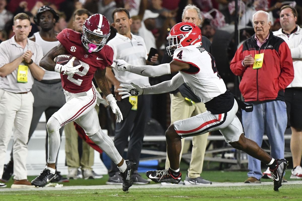 Sep 28, 2024; Tuscaloosa, Alabama, USA;  Alabama Crimson Tide wide receiver Ryan Williams (2) breaks a tackle by Georgia Bulldogs defensive back KJ Bolden (4) to score a touchdown that put Alabama ahead in the fourth quarter at Bryant-Denny Stadium. Alabama defeated Georgia 41-34. Mandatory Credit: Gary Cosby Jr.-Imagn Images