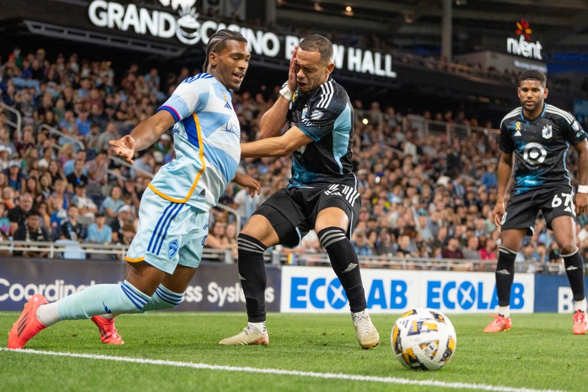 Sep 28, 2024; Saint Paul, Minnesota, USA; Colorado Rapids forward Kimani Stewart-Baynes (27) fights for possession with Minnesota United midfielder Hassani Dotson (31) while fighting for possession in the second half at Allianz Field. Mandatory Credit: Matt Blewett-Imagn Images
