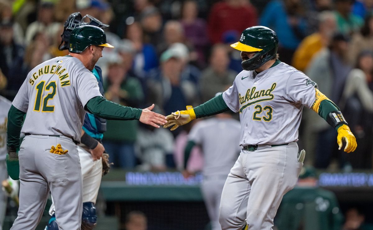 Sep 28, 2024; Seattle, Washington, USA; Oakland Athletics catcher Shea Langeliers (23) is congratulated by second baseman Max Schuemann (12) after hitting a three-run home run during the ninth inning at T-Mobile Park. Mandatory Credit: Stephen Brashear-Imagn Images