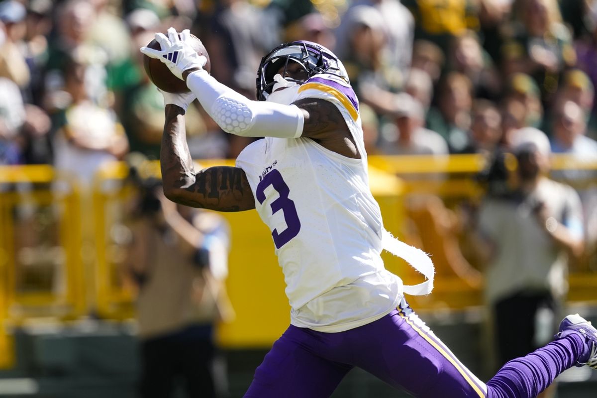Sep 29, 2024; Green Bay, Wisconsin, USA;  Minnesota Vikings wide receiver Jordan Addison (3) catches a pass to score a touchdown during the first quarter against the Green Bay Packers at Lambeau Field. Mandatory Credit: Jeff Hanisch-Imagn Images