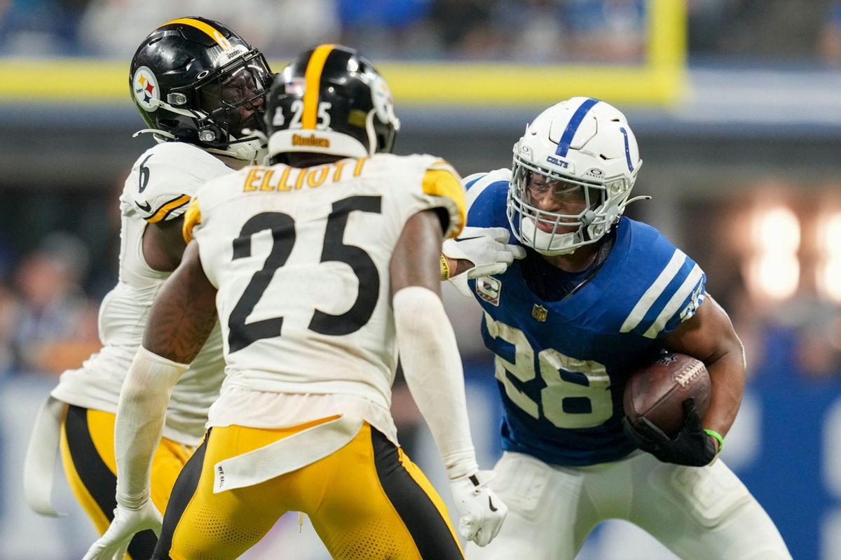 Indianapolis Colts running back Jonathan Taylor (28) looks to rush past Pittsburgh Steelers safety DeShon Elliott (25) and Pittsburgh Steelers linebacker Patrick Queen (6) on Sunday, Sept. 29, 2024, during a game against the Pittsburgh Steelers at Lucas Oil Stadium in Indianapolis.