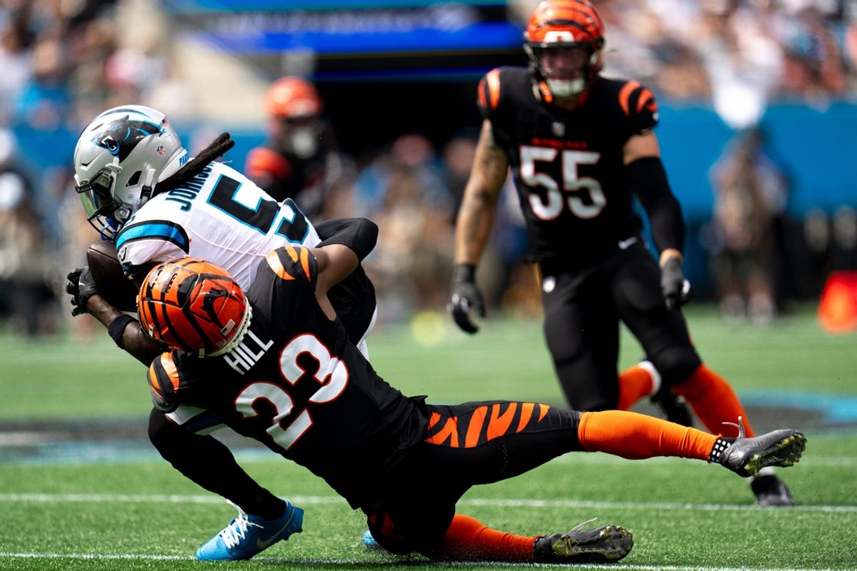 Cincinnati Bengals cornerback Dax Hill (23) tackles Carolina Panthers wide receiver Diontae Johnson (5) in the second quarter of the NFL game at Bank of America Stadium in Charlotte, N.C., on Sunday, Sept. 29, 2024.