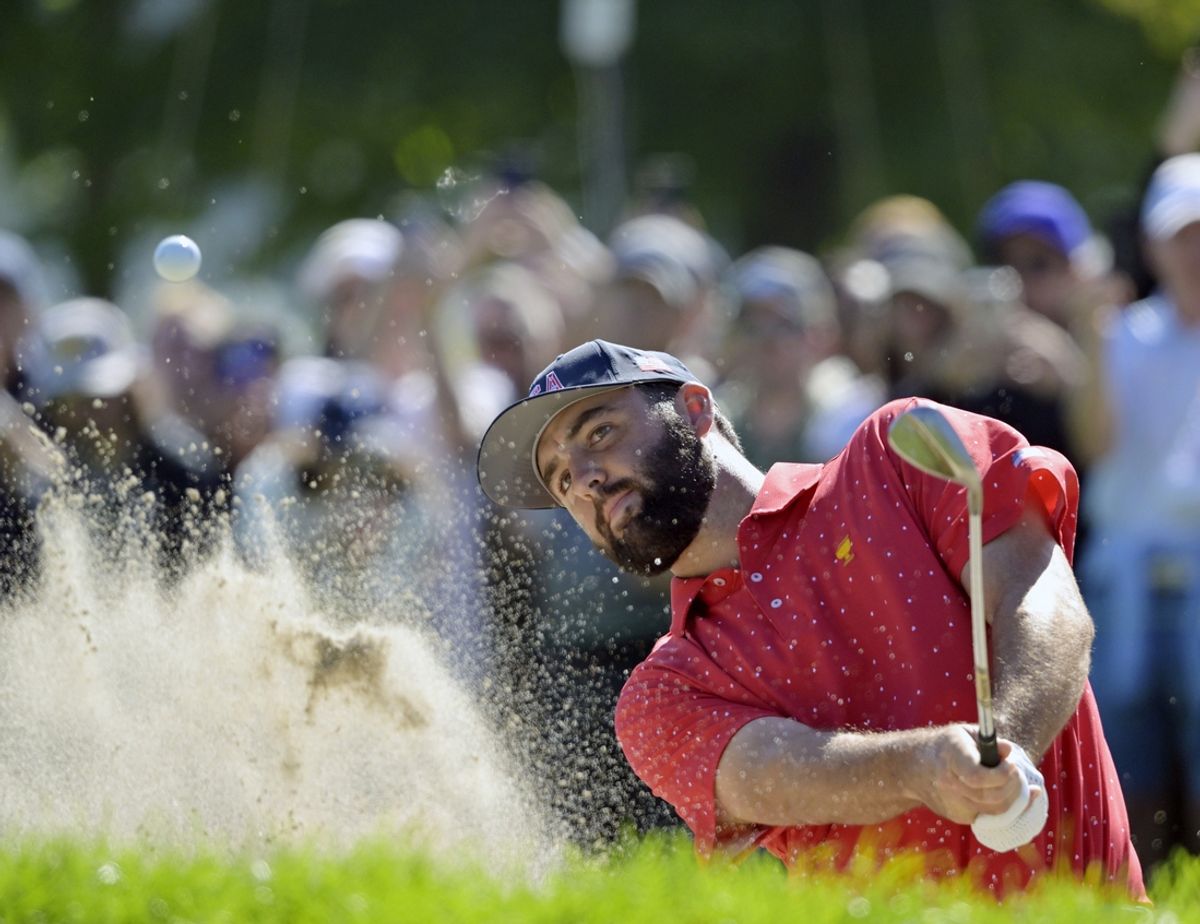 Sep 29, 2024; Ile Bizard, Quebec, CAN; Scottie Scheffler of team USA makes a bunker shot to birdie on the green of the first hole in singles match during the final round of The Presidents Cup golf tournament. Mandatory Credit: Eric Bolte-Imagn Images