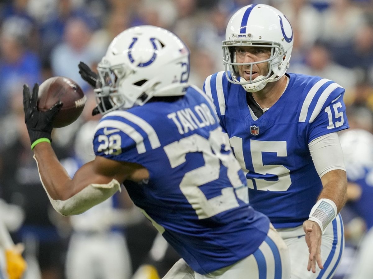 Sep 29, 2024; Indianapolis, Indiana, USA; Indianapolis Colts quarterback Joe Flacco (15) tosses the ball to Indianapolis Colts running back Jonathan Taylor (28) on Sunday, Sept. 29, 2024, during a game against the Pittsburgh Steelers at Lucas Oil Stadium in Indianapolis. Mandatory Credit: Grace Smith-USA TODAY Network via Imagn Images