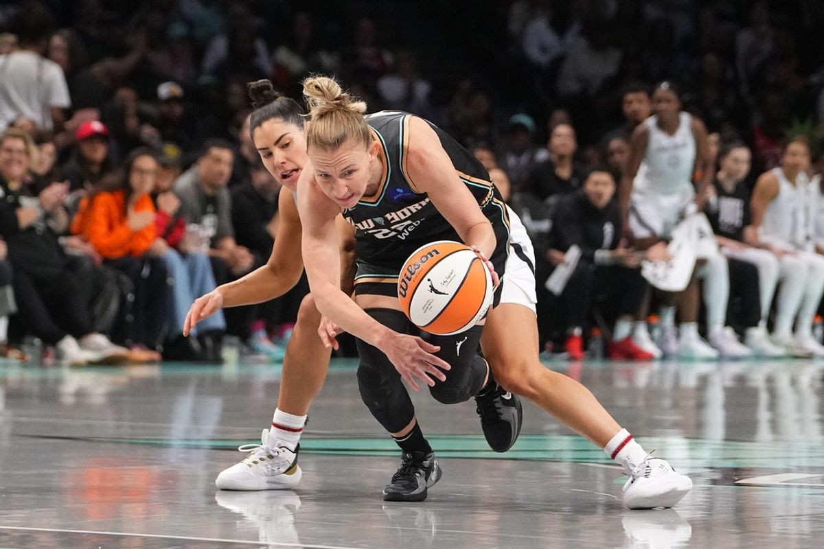 Sep 29, 2024; Brooklyn, New York, USA; New York Liberty guard Courtney Vandersloot (22) grabs a loose ball against the Las Vegas Aces during game one of the 2024 WNBA Semi-finals at Barclays Center. Mandatory Credit: Gregory Fisher-Imagn Images