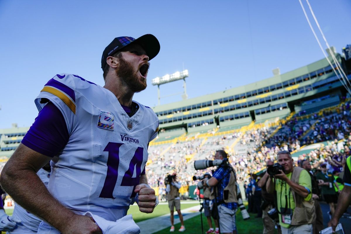 Sep 29, 2024; Green Bay, Wisconsin, USA;  Minnesota Vikings quarterback Sam Darnold (14) cheers as he leaves the field following the game against the Green Bay Packers at Lambeau Field. Mandatory Credit: Jeff Hanisch-Imagn Images