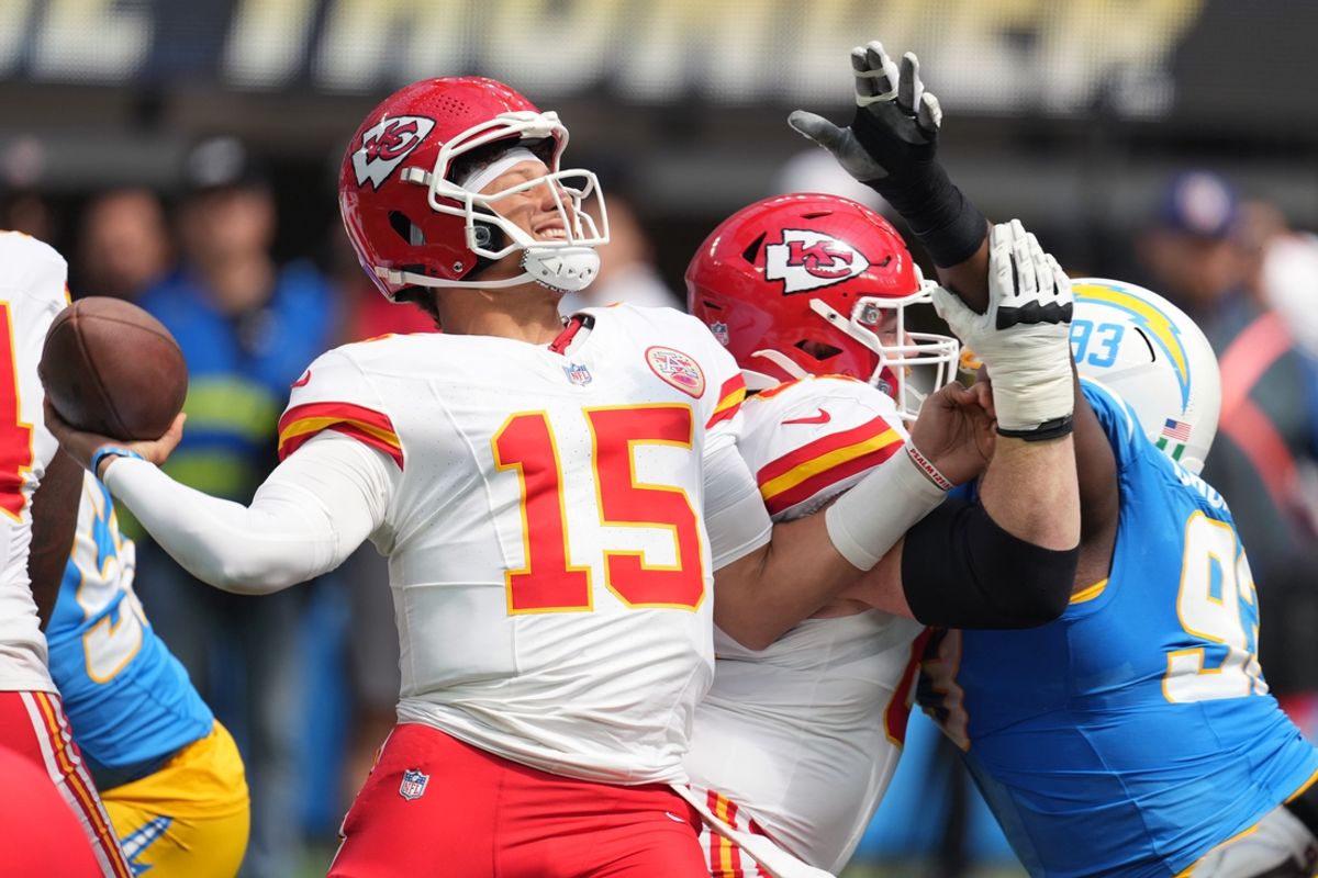 Sep 29, 2024; Inglewood, California, USA; Kansas City Chiefs quarterback Patrick Mahomes (15) throws the ball under pressure from Los Angeles Chargers defensive tackle Otito Ogbonnia (93) in the first quarter at SoFi Stadium. Mandatory Credit: Kirby Lee-Imagn Images