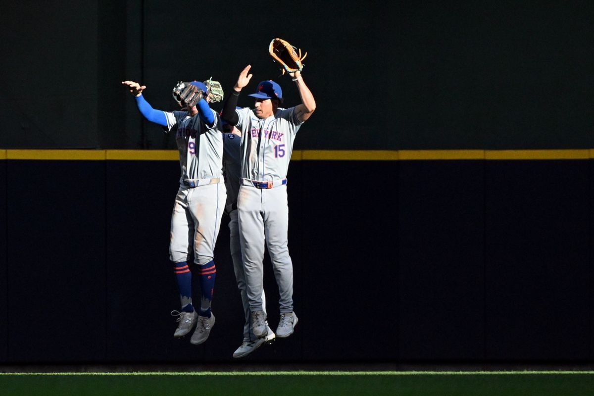 Sep 29, 2024; Milwaukee, Wisconsin, USA; New York Mets outfielder Brandon Nimmo (9), New York Mets outfielder Tyrone Taylor (15) and not seen New York Mets outfielder Harrison Bader (44) celebrate a 5-0 win over the Milwaukee Brewers at American Family Field. Mandatory Credit: Michael McLoone-Imagn Images
