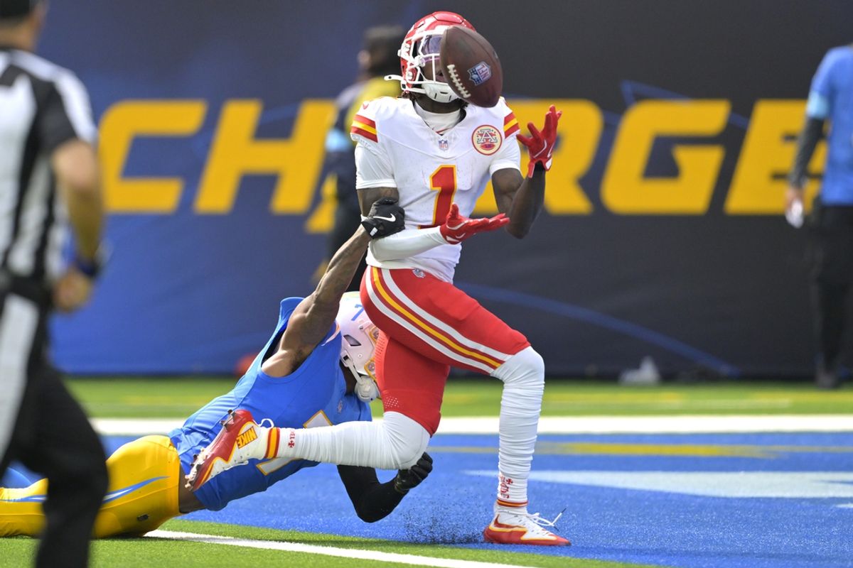Sep 29, 2024; Inglewood, California, USA;  Kansas City Chiefs wide receiver Xavier Worthy (1) is defended by Los Angeles Chargers cornerback Kristian Fulton (7) as he hangs on to a touchdown pass in the first half at SoFi Stadium. Mandatory Credit: Jayne Kamin-Oncea-Imagn Images