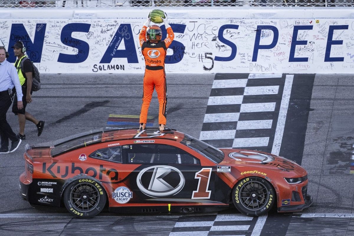 Sep 29, 2024; Kansas City, Kansas, USA; NASCAR Cup Series driver Ross Chastain (1) smashes a watermelon following his victory at the Hollywood Casino 400 at Kansas Speedway. Mandatory Credit: Amy Kontras-Imagn Images