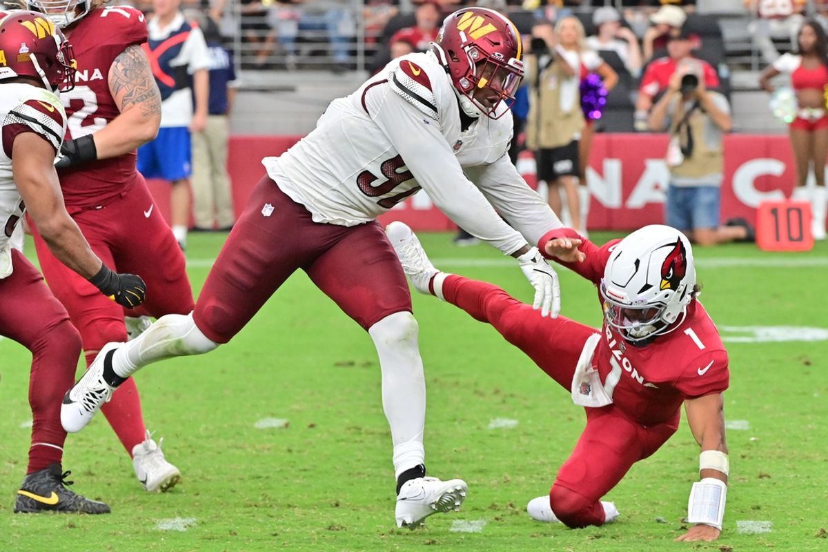 Sep 29, 2024; Glendale, Arizona, USA;  Washington Commanders defensive end Dorance Armstrong (92) pushes Arizona Cardinals quarterback Kyler Murray (1) to the ground in the second half at State Farm Stadium. Mandatory Credit: Matt Kartozian-Imagn Images