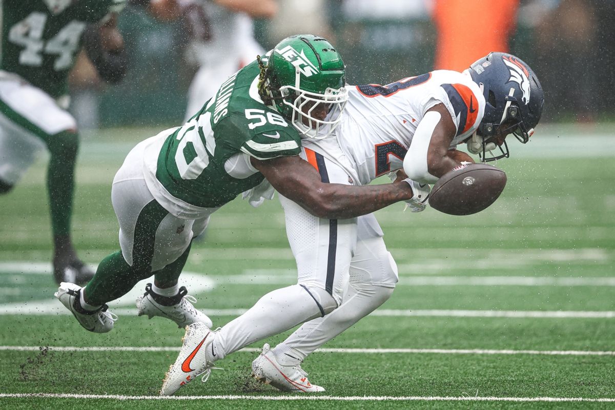 Sep 29, 2024; East Rutherford, New Jersey, USA; Denver Broncos running back Tyler Badie (28) fumbles after being hit by New York Jets linebacker Quincy Williams (56) during the first half at MetLife Stadium. Mandatory Credit: Vincent Carchietta-Imagn Images