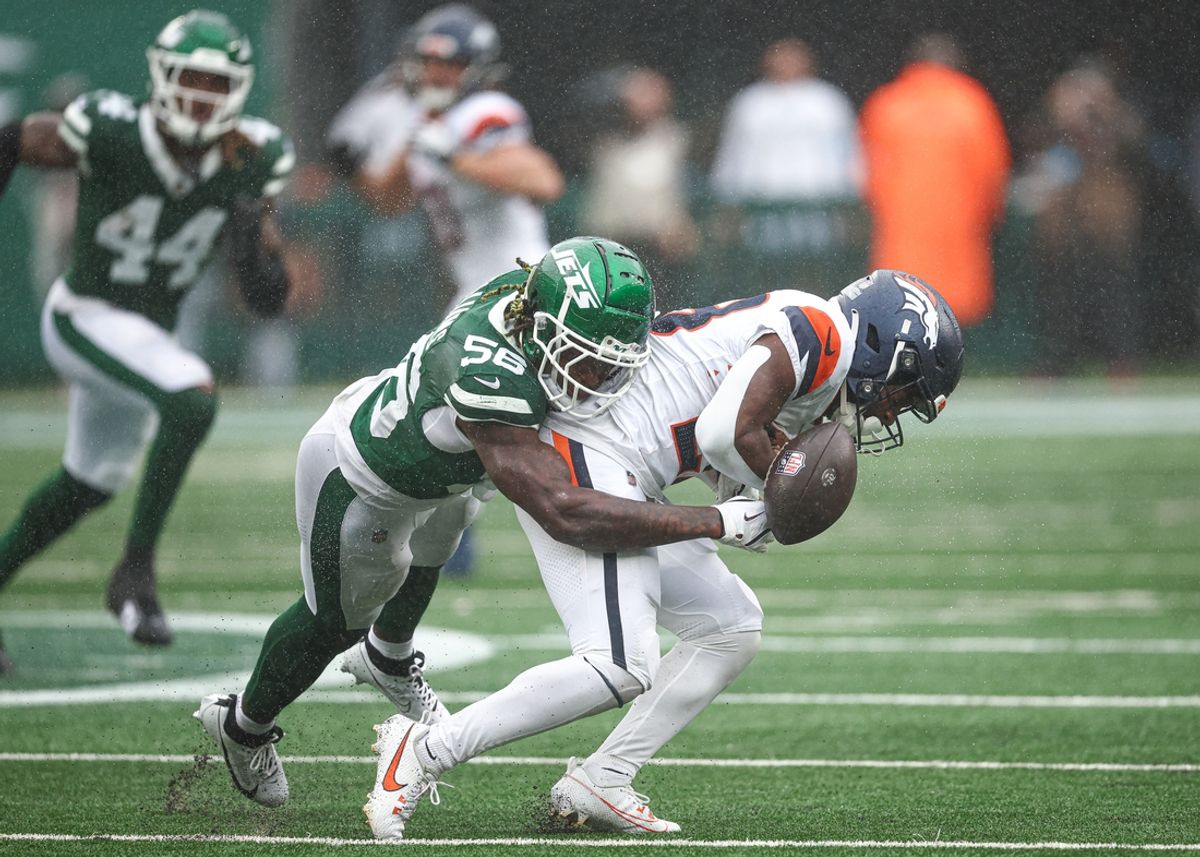 Sep 29, 2024; East Rutherford, New Jersey, USA; Denver Broncos running back Tyler Badie (28) fumbles after being hit by New York Jets linebacker Quincy Williams (56) during the first half at MetLife Stadium. Mandatory Credit: Vincent Carchietta-Imagn Images