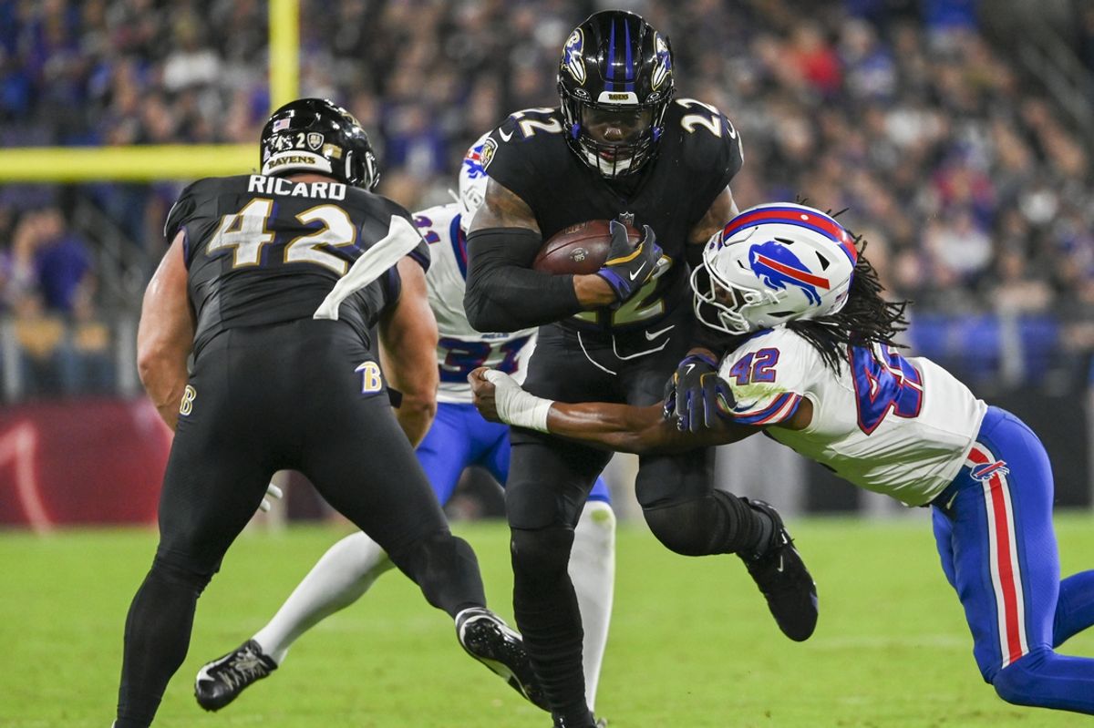 Sep 29, 2024; Baltimore, Maryland, USA;  Baltimore Ravens running back Derrick Henry (22) runs through Buffalo Bills linebacker Dorian Williams (42) tackle attempt during the first half  at M&T Bank Stadium. Mandatory Credit: Tommy Gilligan-Imagn Images