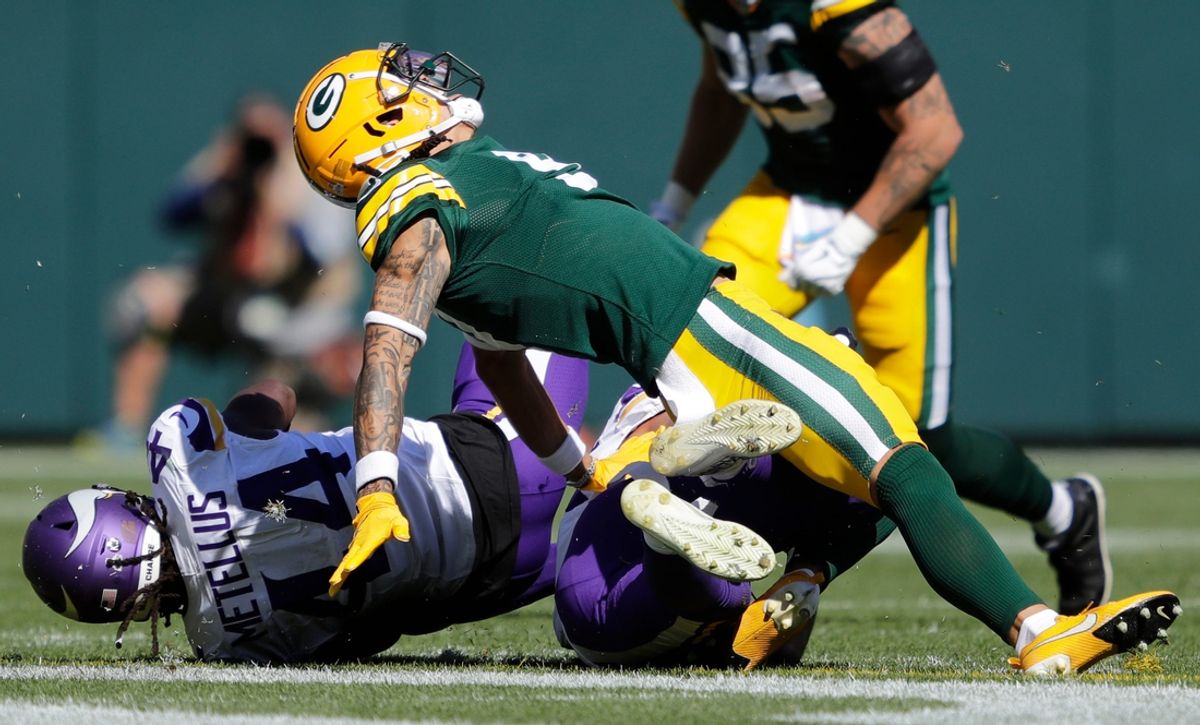 Green Bay Packers wide receiver Christian Watson (9) is injured as he is tackled by Minnesota Vikings safety Josh Metellus (44) during their football game Sunday, September 29, 2024, at Lambeau Field in Green Bay, Wisconsin.