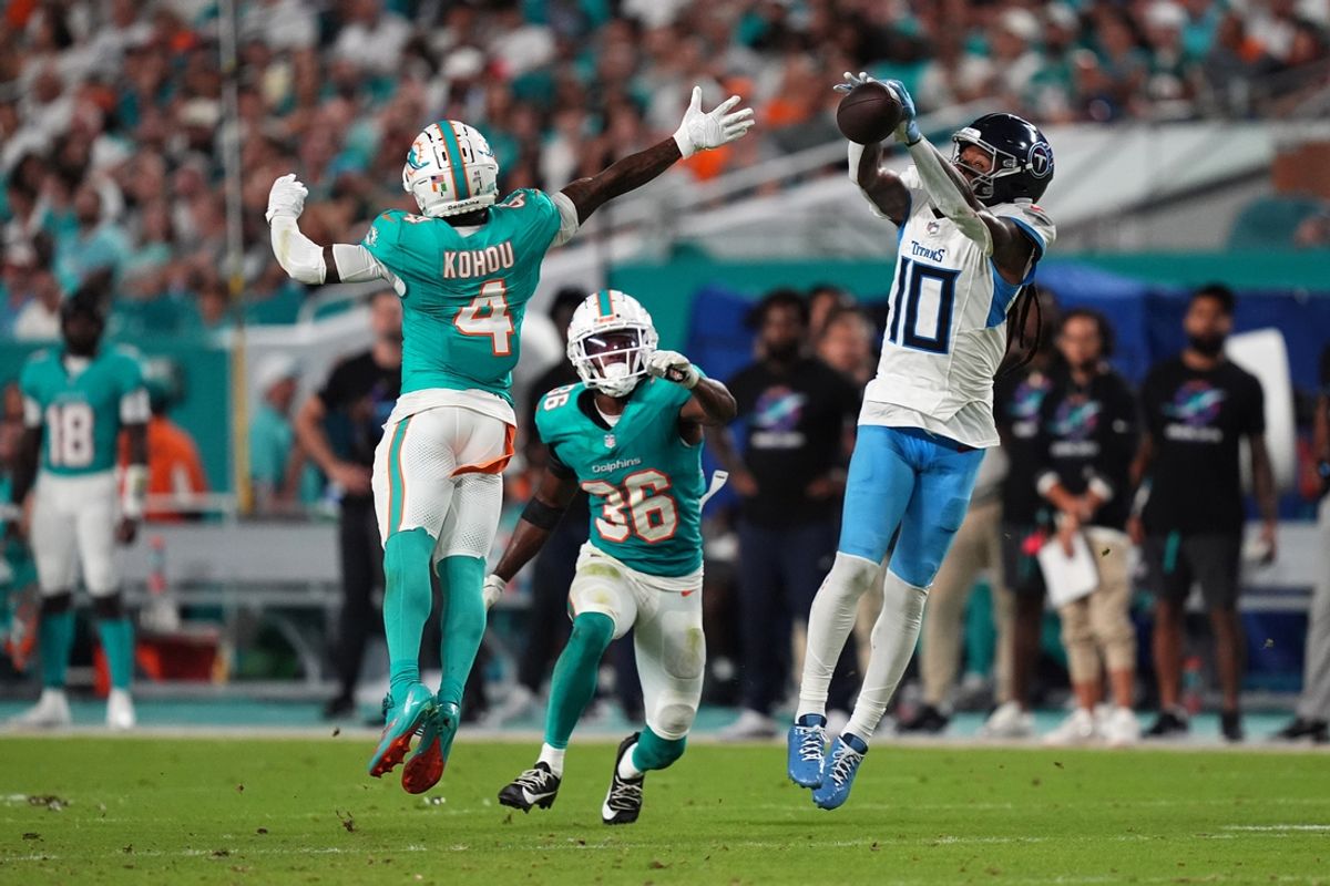 Sep 30, 2024; Miami Gardens, Florida, USA; Tennessee Titans wide receiver DeAndre Hopkins (10) attempts to make a catch behind Miami Dolphins cornerback Kader Kohou (4) during the first half at Hard Rock Stadium. Mandatory Credit: Jasen Vinlove-Imagn Images