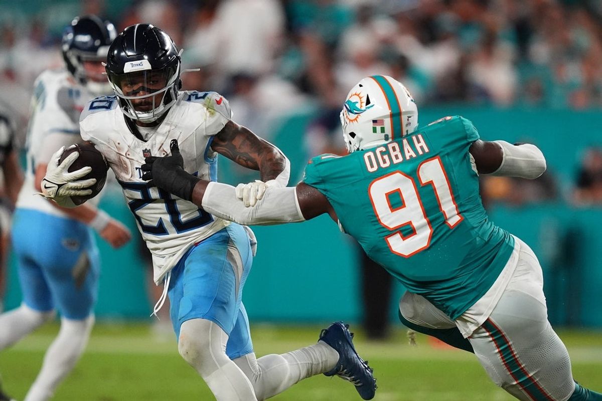 Sep 30, 2024; Miami Gardens, Florida, USA; Miami Dolphins linebacker Emmanuel Ogbah (91) reaches for Tennessee Titans running back Tony Pollard (20) during the second half at Hard Rock Stadium. Mandatory Credit: Jasen Vinlove-Imagn Images