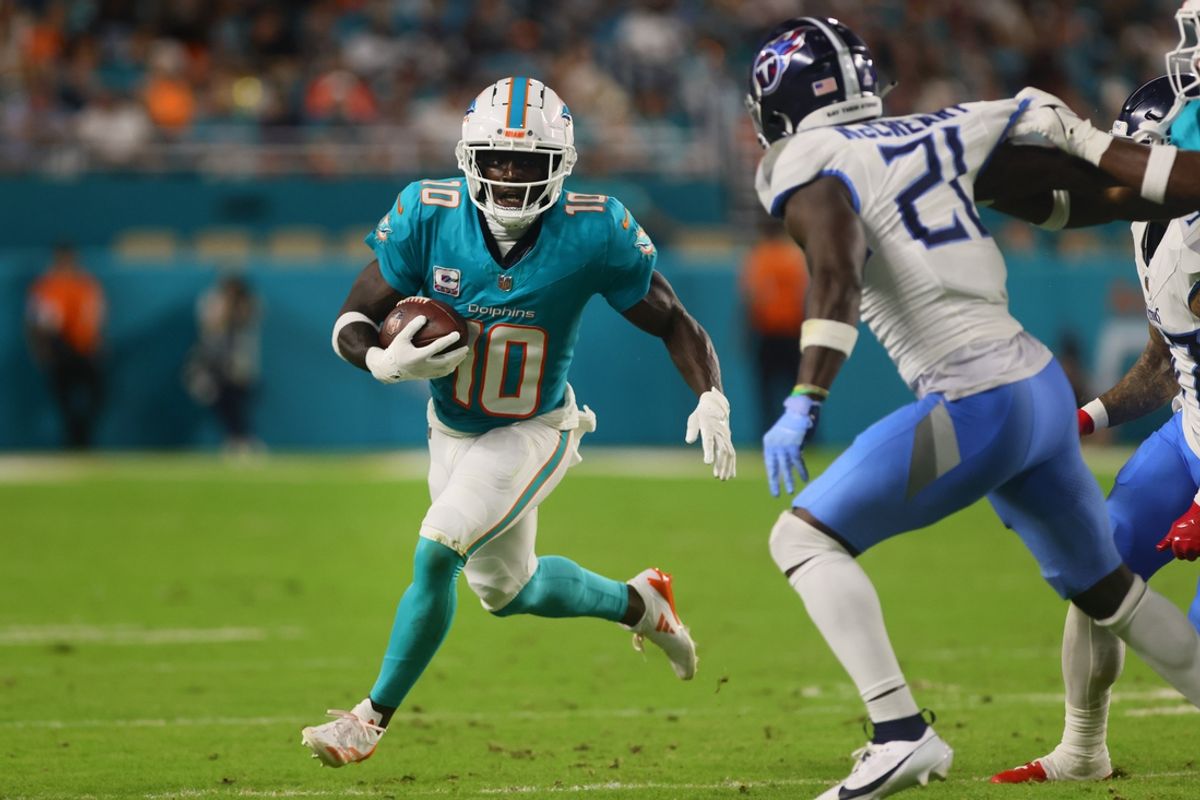 Sep 30, 2024; Miami Gardens, Florida, USA; Miami Dolphins wide receiver Tyreek Hill (10) runs with the football against the Tennessee Titans during the third quarter at Hard Rock Stadium. Mandatory Credit: Sam Navarro-Imagn Images