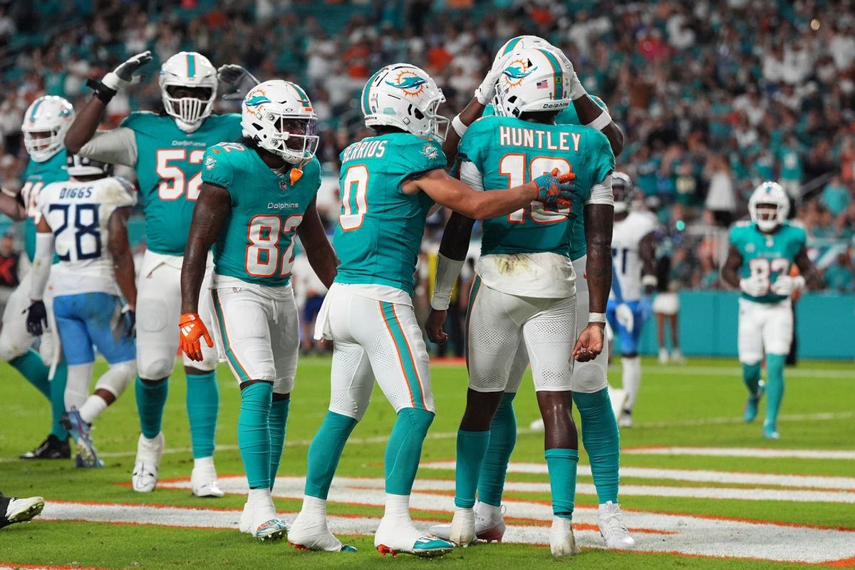 Sep 30, 2024; Miami Gardens, Florida, USA; Miami Dolphins quarterback Tyler Huntley (18) celebrates with teammates after scoring a touchdown during the second half against the Tennessee Titans at Hard Rock Stadium. Mandatory Credit: Jasen Vinlove-Imagn Images