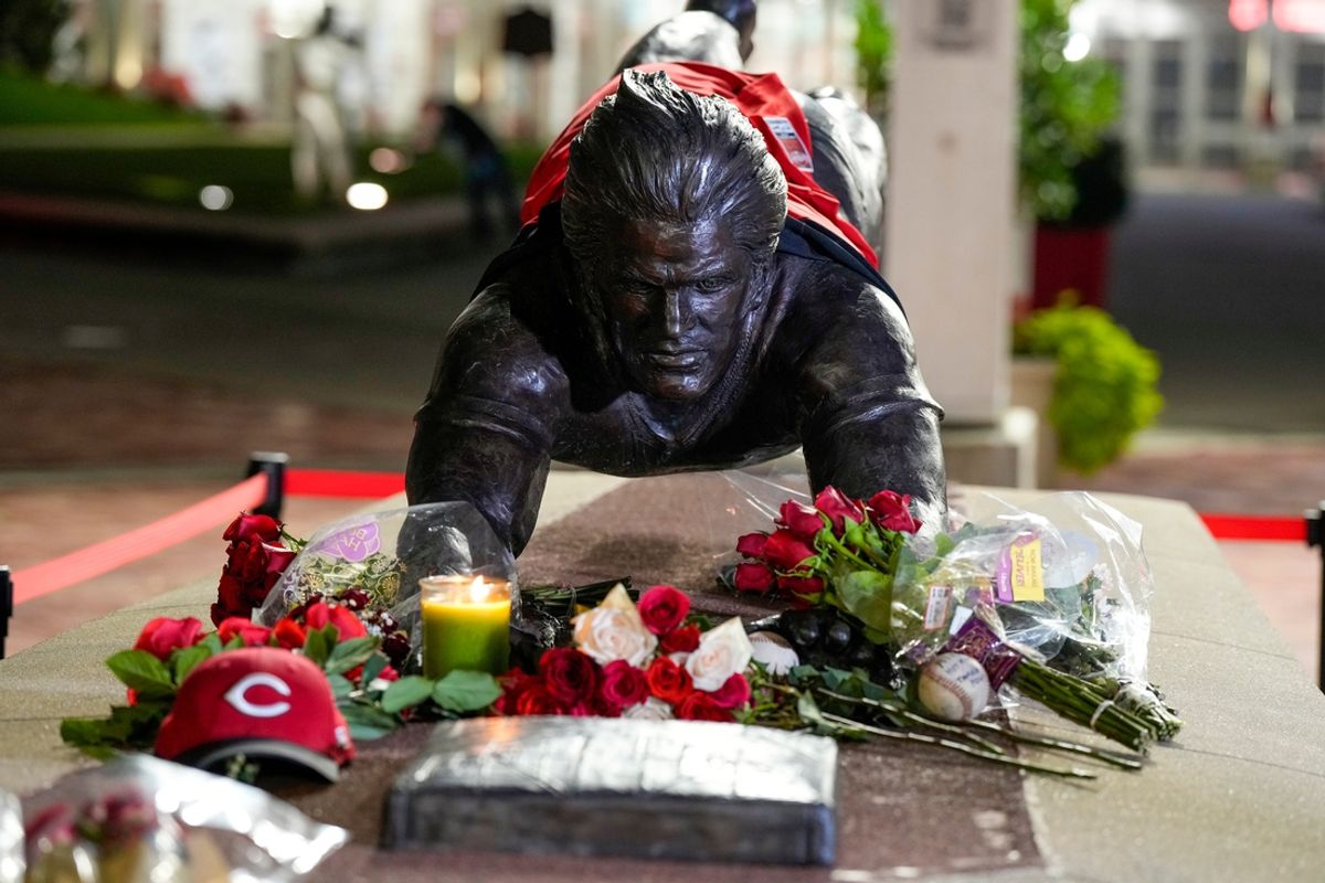 Roses and other items were placed at the statue of former Cincinnati Reds player Pete Rose outside of Great American Ball Park in downtown Cincinnati on Monday, Sept. 30, 2024. News broke Monday night that the Cincinnati native had died at the age of 83.