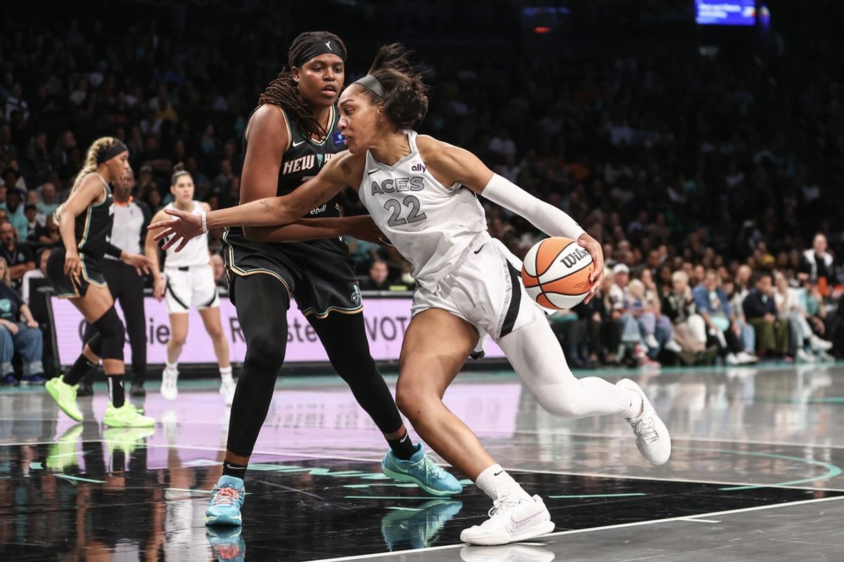 Oct 1, 2024; Brooklyn, New York, USA; Las Vegas Aces center A'ja Wilson (22) drives past New York Liberty forward Jonquel Jones (35) during game two of the 2024 WNBA Semi-finals at Barclays Center. Mandatory Credit: Wendell Cruz-Imagn Images