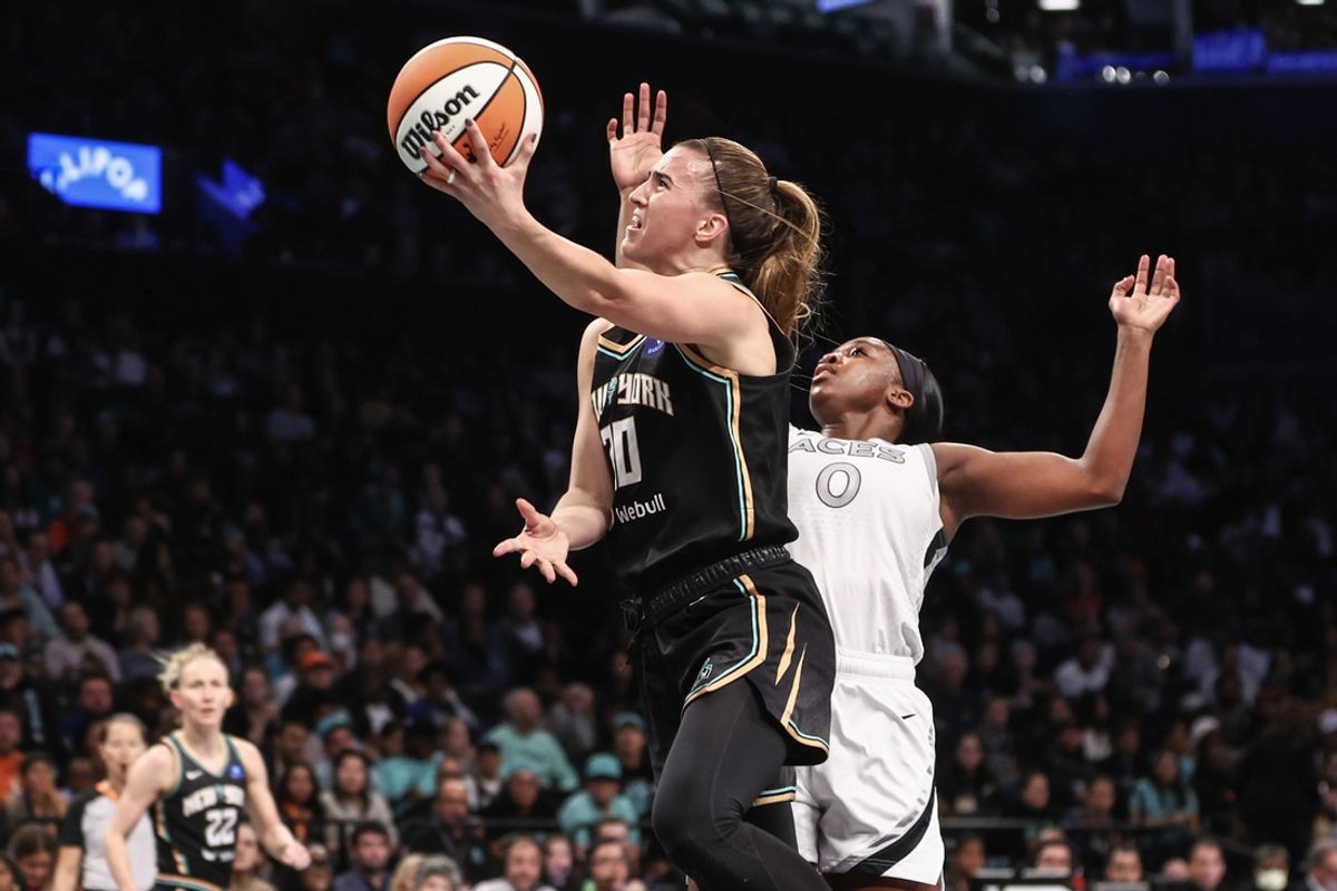 Oct 1, 2024; Brooklyn, New York, USA; New York Liberty guard Sabrina Ionescu (20) drives past Las Vegas Aces guard Jackie Young (0) in the third quarter during game two of the 2024 WNBA Semi-finals at Barclays Center. Mandatory Credit: Wendell Cruz-Imagn Images