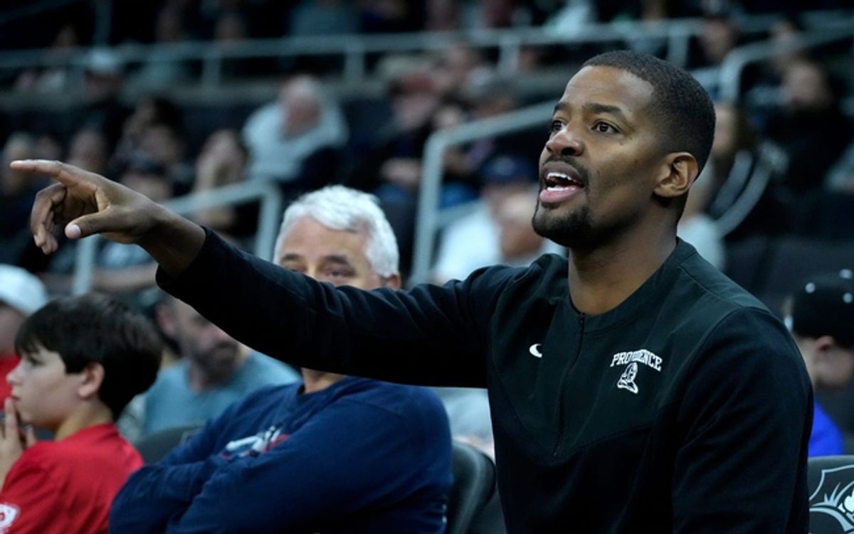 Providence Friars head coach Kim English throws out instructions while watching the Mal Brown scrimmage form the side lines.