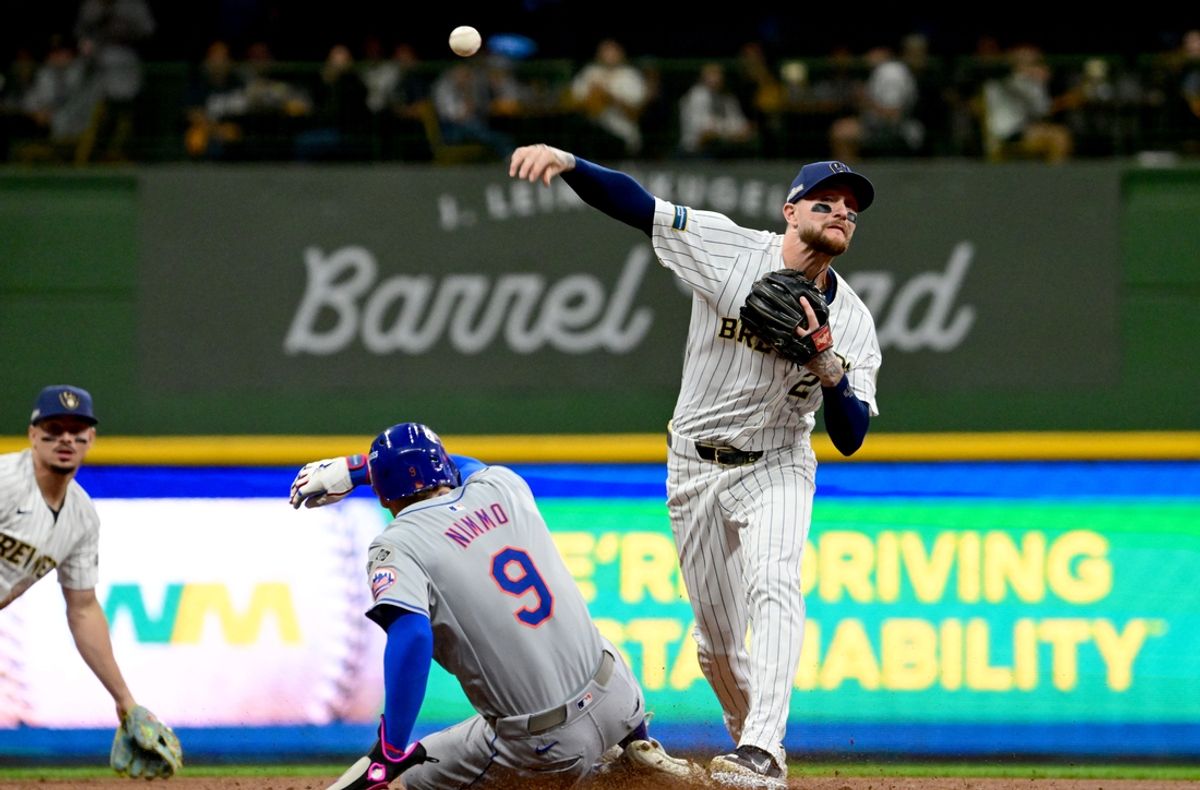 Oct 2, 2024; Milwaukee, Wisconsin, USA; Milwaukee Brewers second baseman Brice Turang (2) throws to first during the first inning in game two of the Wildcard round for the 2024 MLB Playoffs against the New York Mets at American Family Field. Mandatory Credit: Benny Sieu-Imagn Images