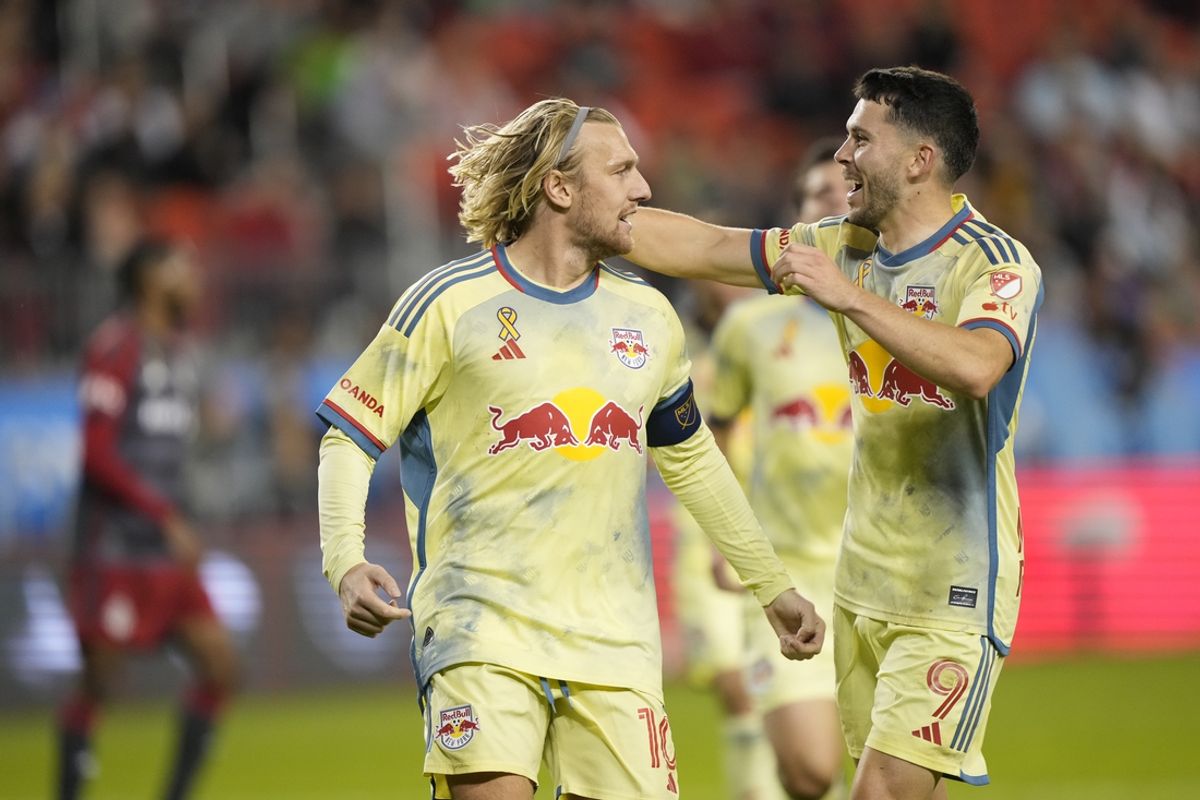Oct 2, 2024; Toronto, Ontario, CAN; New York Red Bulls midfielder Emil Forsberg (10) celebrates goal with midfielder Lewis Morgan (9) in the first half against the Toronto FC at BMO Field. Mandatory Credit: John E. Sokolowski-Imagn Images