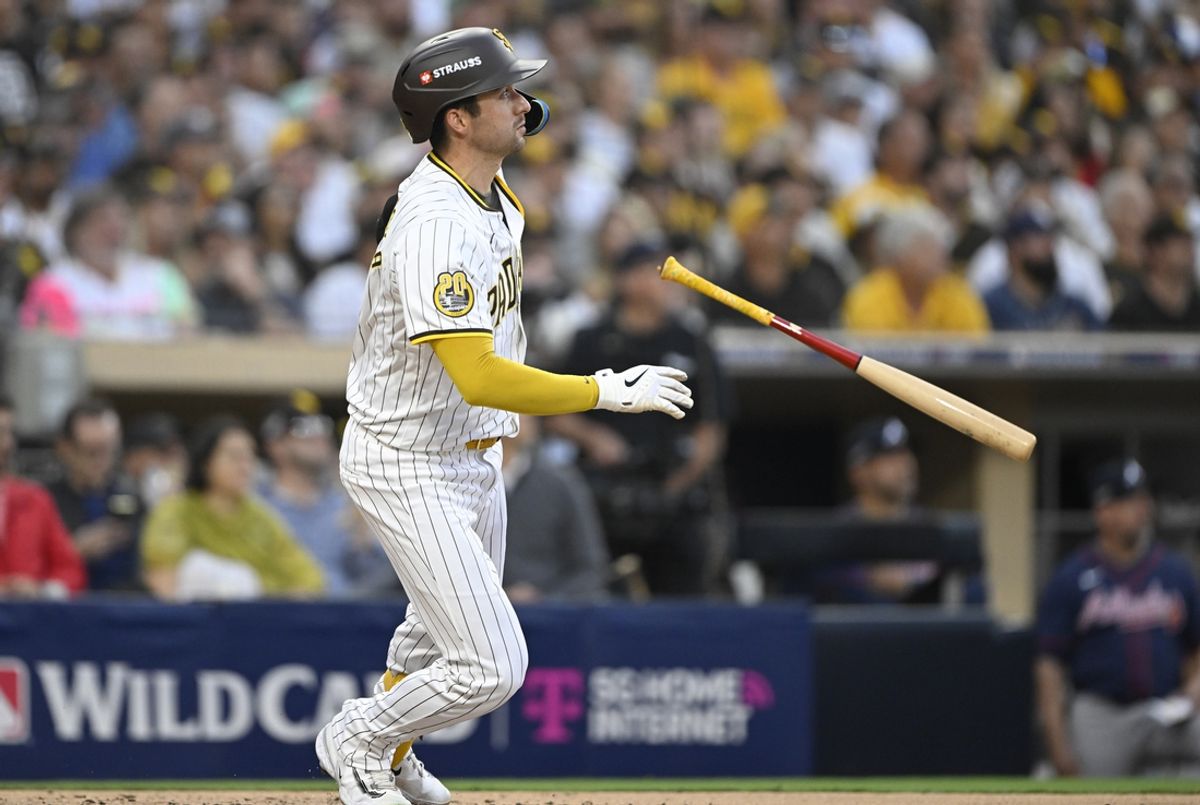 Oct 2, 2024; San Diego, California, USA; San Diego Padres catcher Kyle Higashioka (20) hits a solo home run during the second inning of game two in the Wildcard round for the 2024 MLB Playoffs against the Atlanta Braves at Petco Park. Mandatory Credit: Denis Poroy-Imagn Images