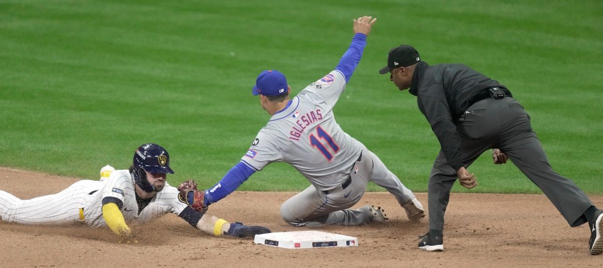 Milwaukee Brewers outfielder Garrett Mitchell (5) is tagged out while attempting to steal second base by New York Mets second baseman Jose Iglesias (11) during the sixth inning of their wild-card playoff game Wednesday, October 2, 2024 at American Family Field in Milwaukee, Wisconsin.