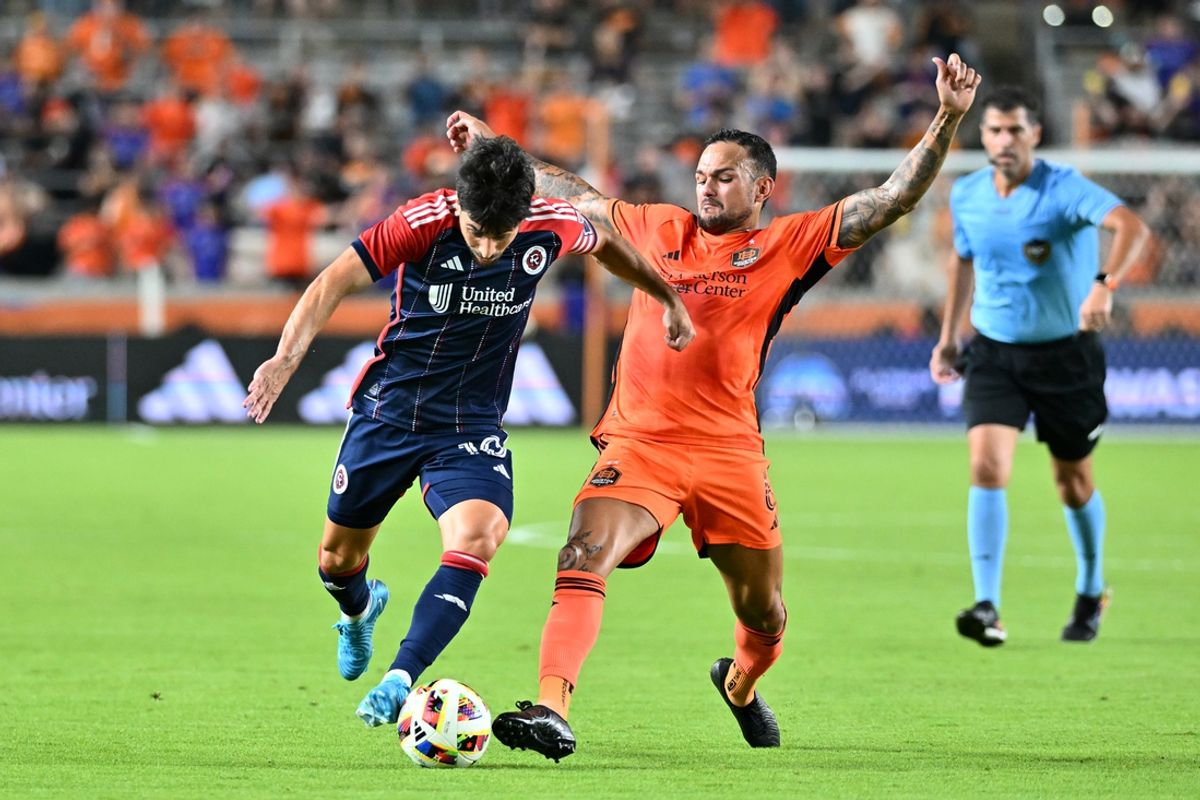 Oct 2, 2024; Houston, Texas, USA; New England Revolution midfielder Carles Gil (10) and Houston Dynamo FC midfielder Artur (6) battle for the ball in the second half at Shell Energy Stadium. Mandatory Credit: Maria Lysaker-Imagn Images