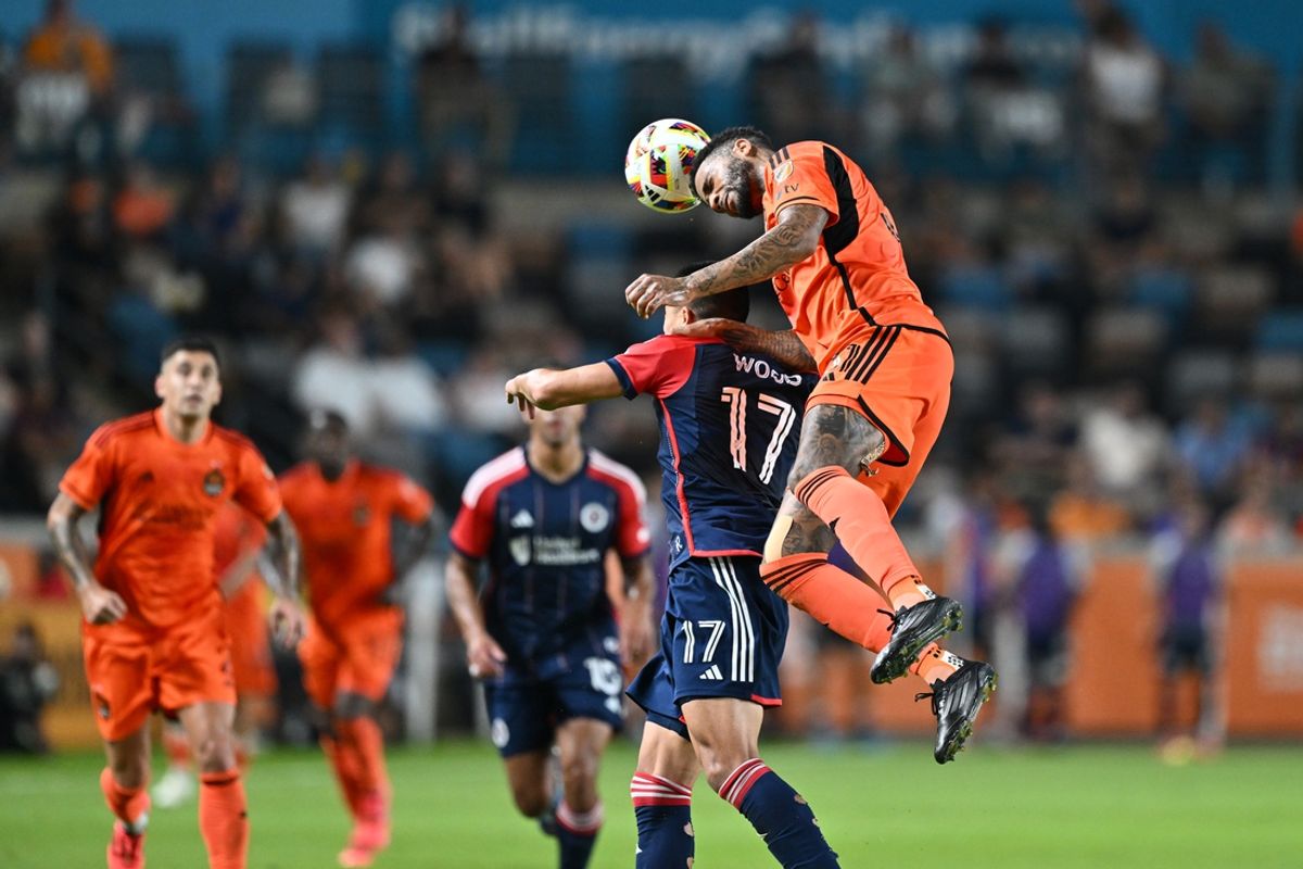 Oct 2, 2024; Houston, Texas, USA; Houston Dynamo FC defender Micael dos Santos (31) heads the ball against New England Revolution forward Bobby Wood (17) in the second half at Shell Energy Stadium. Mandatory Credit: Maria Lysaker-Imagn Images