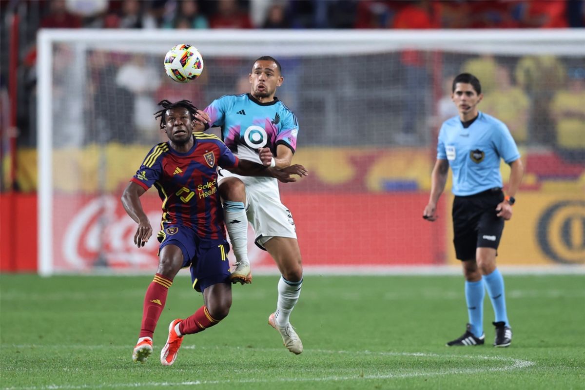 Oct 2, 2024; Sandy, Utah, USA; Real Salt Lake midfielder Emeka Eneli (14) plays the ball defended by Minnesota United midfielder Hassani Dotson (31) in the first half  at America First Field. Mandatory Credit: Rob Gray-Imagn Images