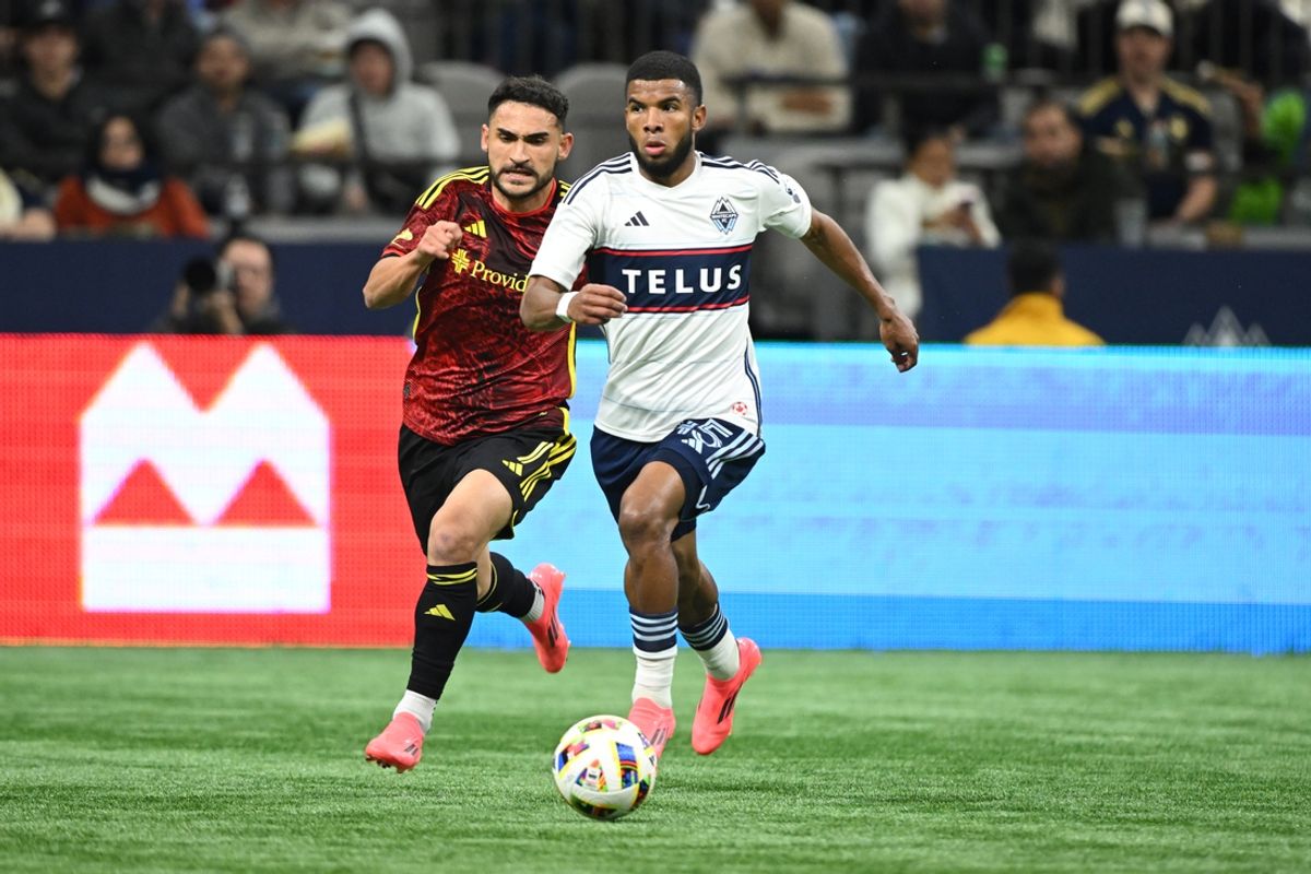 Oct 2, 2024; Vancouver, British Columbia, CAN;  Vancouver Whitecaps FC midfielder Pedro Vite (45) dribbles the ball against Seattle Sounders FC midfielder Cristian Roldan (7) during the second half at BC Place. Mandatory Credit: Anne-Marie Sorvin-Imagn Images