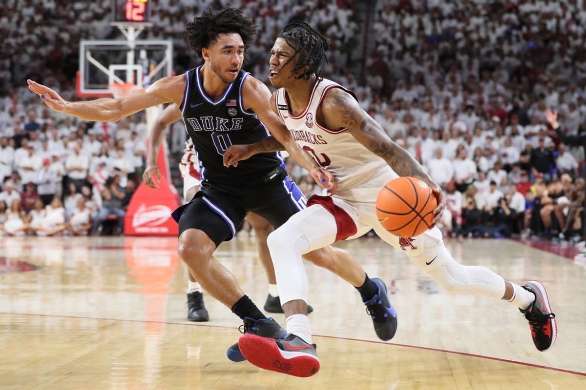Nov 29, 2023; Fayetteville, Arkansas, USA; Arkansas Razorbacks guard Khalif Battle (0) drives against Duke Blue Devils Jared McCain (0) during the second half at Bud Walton Arena. Arkansas won 80-75.