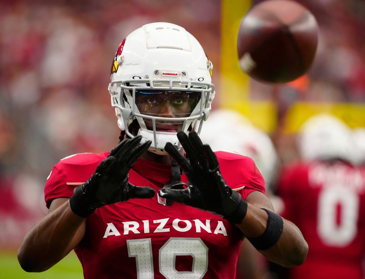 Cardinals wide receiver Marvin Harrison Jr. (18) catches balls on the sideline during a game against the Commanders at State Farm Stadium in Glendale on Sept. 29, 2024.