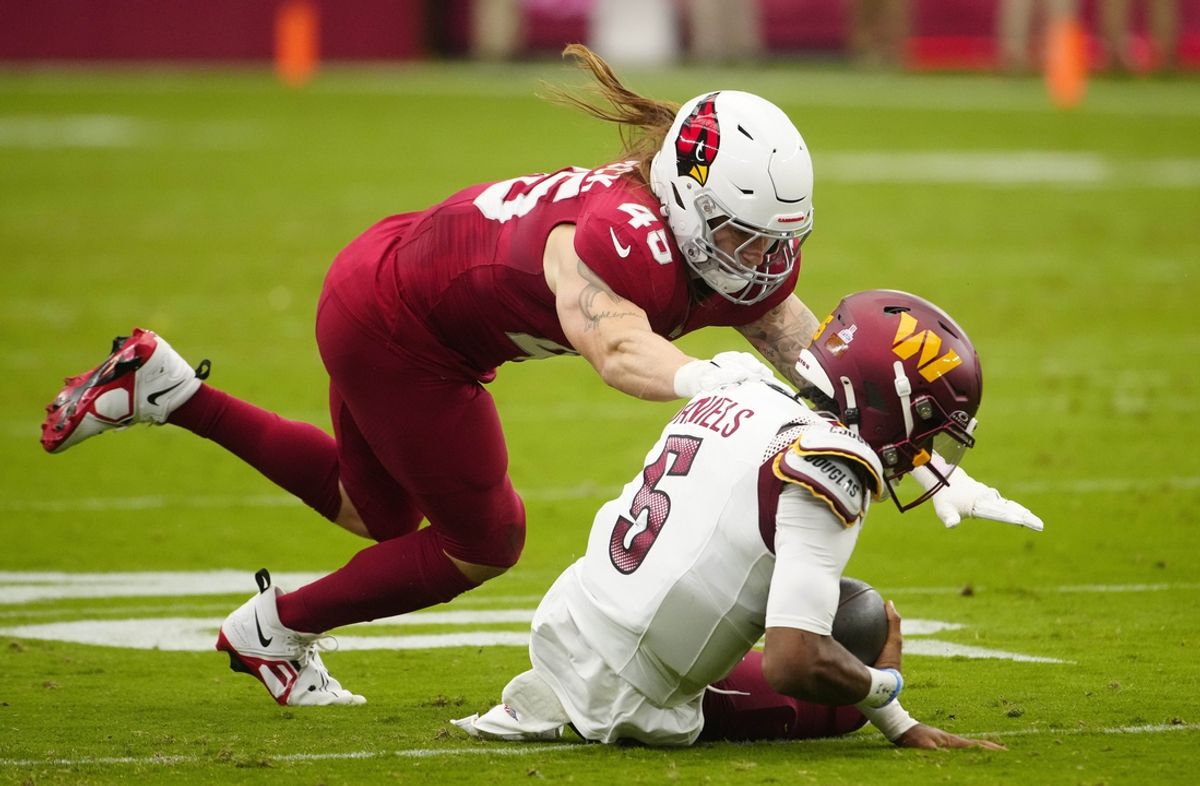 Cardinals linebacker Dennis Gardeck (45) tackles Commanders quarterback Jayden Daniels (5) as he slides during a game at State Farm Stadium in Glendale on Sept. 29, 2024.