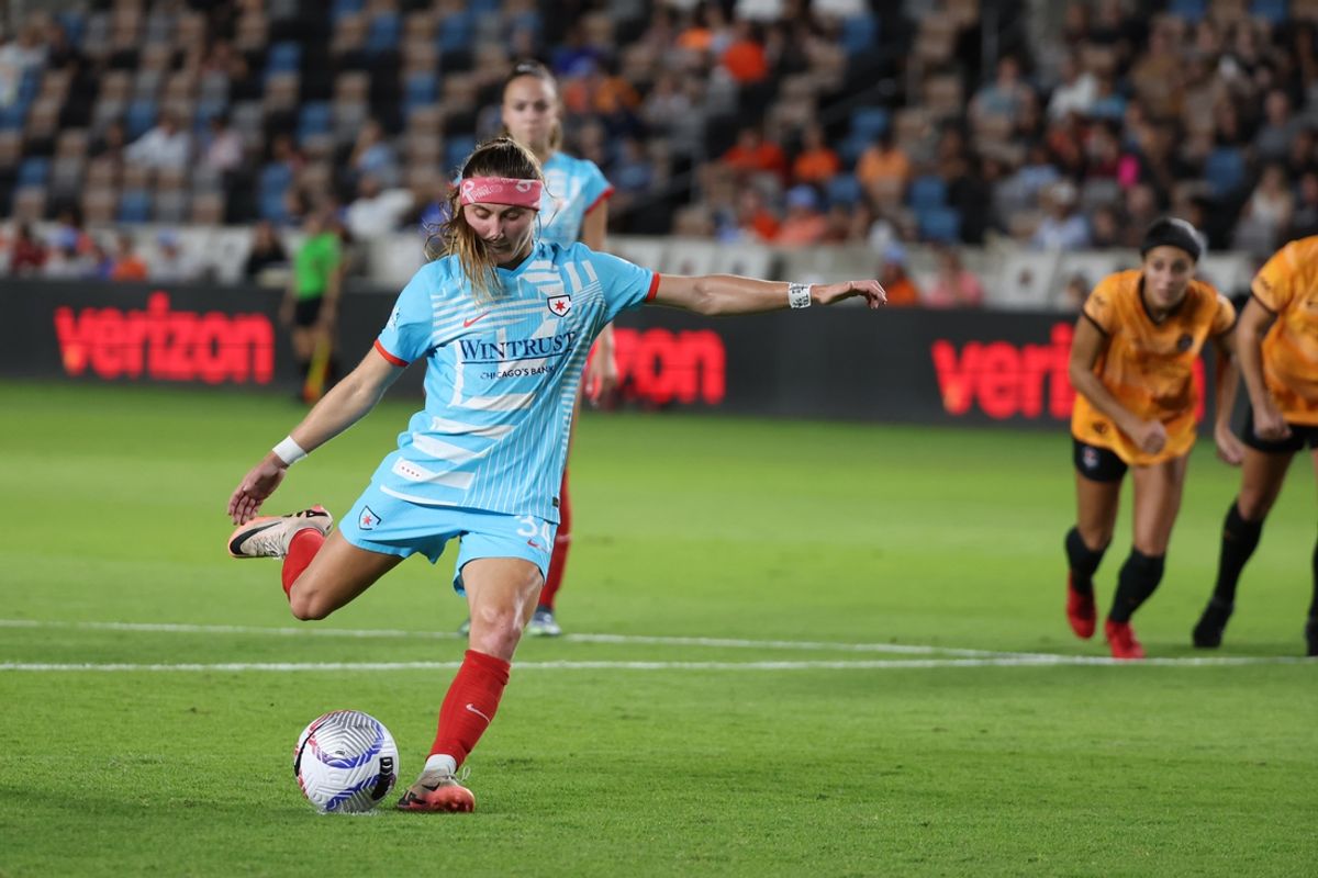 Oct 4, 2024; Houston, Texas, USA;  Chicago Red Stars forward Ally Schlegel (34) shoots and scores on a penalty shot against the Houston Dash during the first half at Shell Energy Stadium. Mandatory Credit: Thomas Shea-Imagn Images