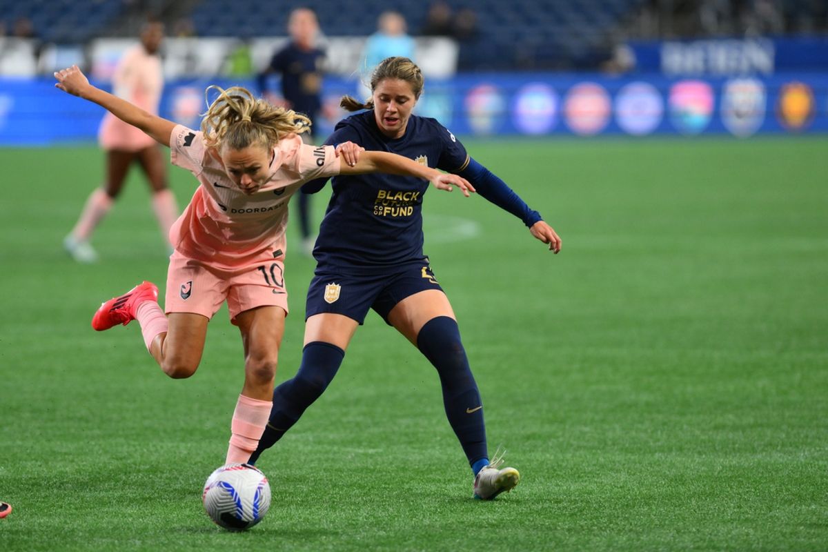 Oct 4, 2024; Seattle, Washington, USA;  Angel City FC forward Claire Emslie (10) battles for the ball against Seattle Reign FC defender Shae Holmes (25) during the first half at Lumen Field. Mandatory Credit: Steven Bisig-Imagn Images