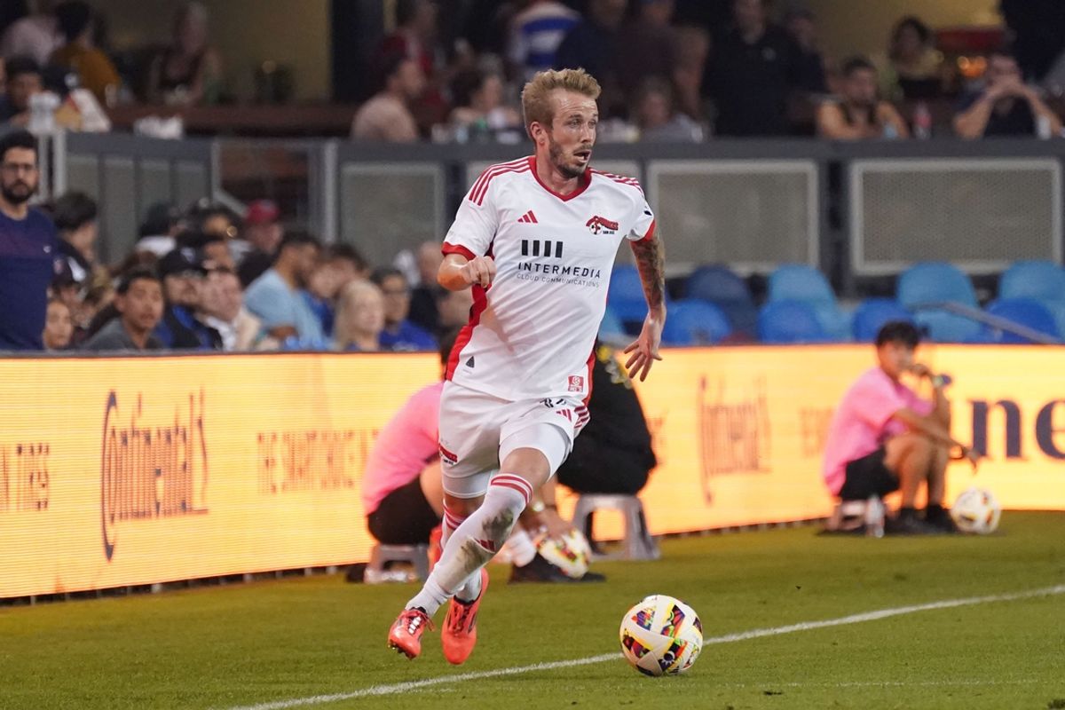 Oct 2, 2024; San Jose, California, USA;  San Jose Earthquakes midfielder Jackson Yueill (14) dribbles upfield in the first half during a game against the Ram's at PayPal Park. Mandatory Credit: David Gonzales-Imagn Images