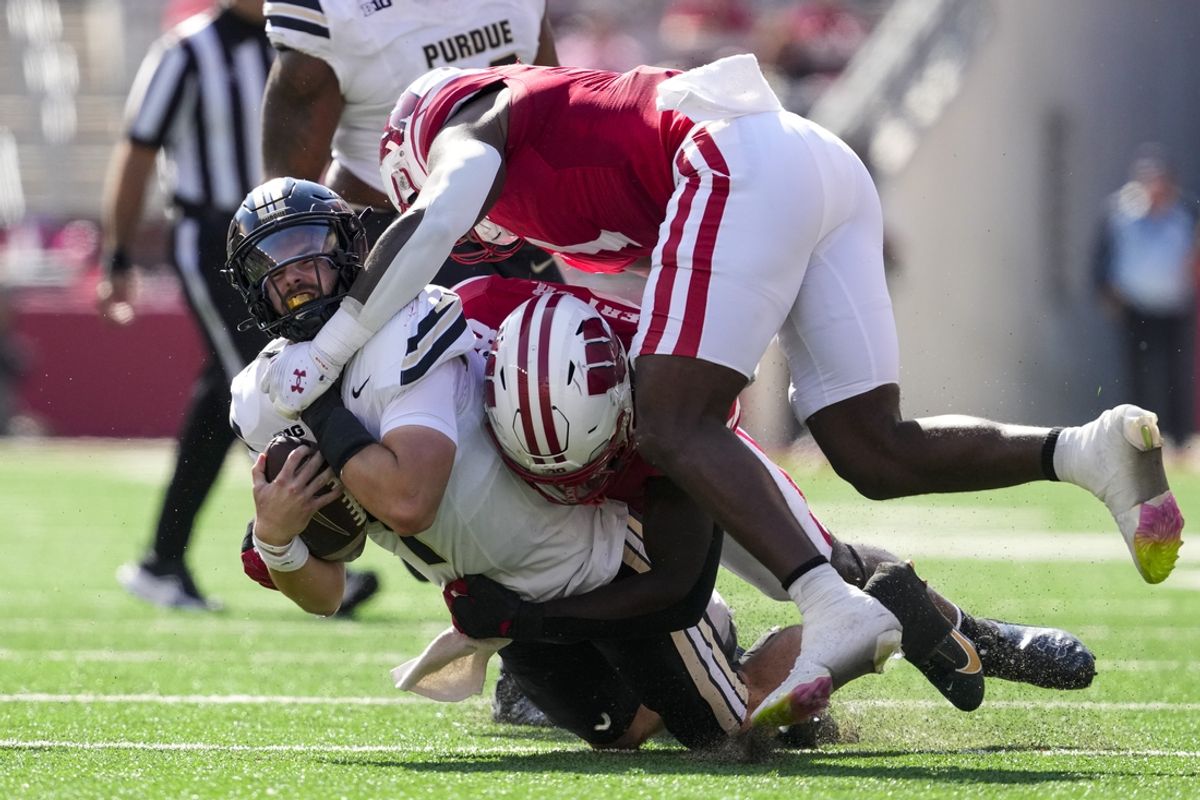 Oct 5, 2024; Madison, Wisconsin, USA;  Purdue Boilermakers quarterback Hudson Card (1) is tackled during the second quarter against the Wisconsin Badgers at Camp Randall Stadium. Mandatory Credit: Jeff Hanisch-Imagn Images