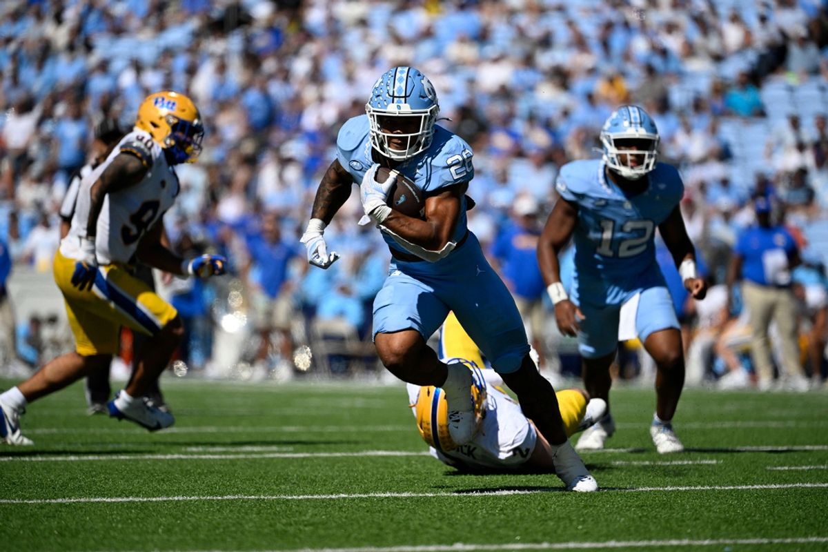 Oct 5, 2024; Chapel Hill, North Carolina, USA; North Carolina Tar Heels running back Omarion Hampton (28) riuns with the ball as Pittsburgh Panthers defensive lineman Nate Matlack (2) defends in the second quarter at Kenan Memorial Stadium. Mandatory Credit: Bob Donnan-Imagn Images