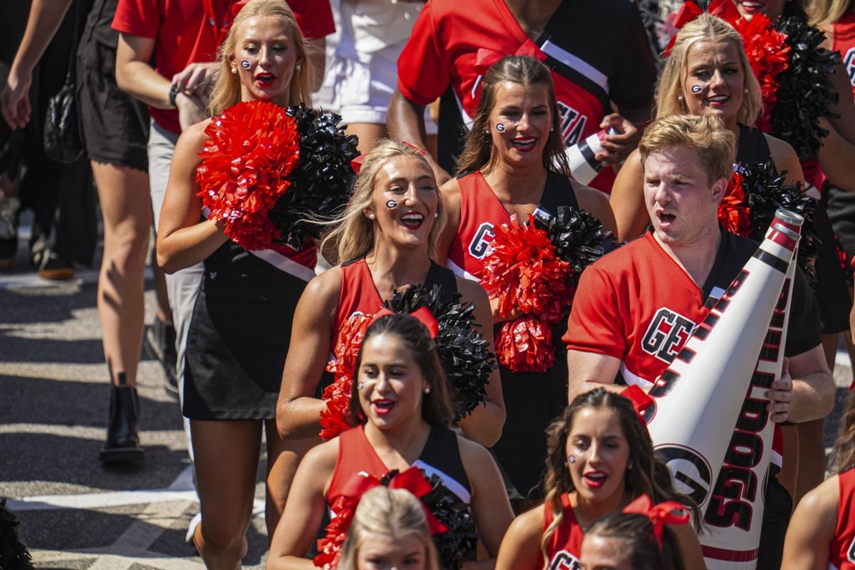 Oct 5, 2024; Athens, Georgia, USA; Georgia Bulldogs cheerleaders walk in with the team during the dawg walk before the game against the Auburn Tigers at Sanford Stadium. Mandatory Credit: Dale Zanine-Imagn Images