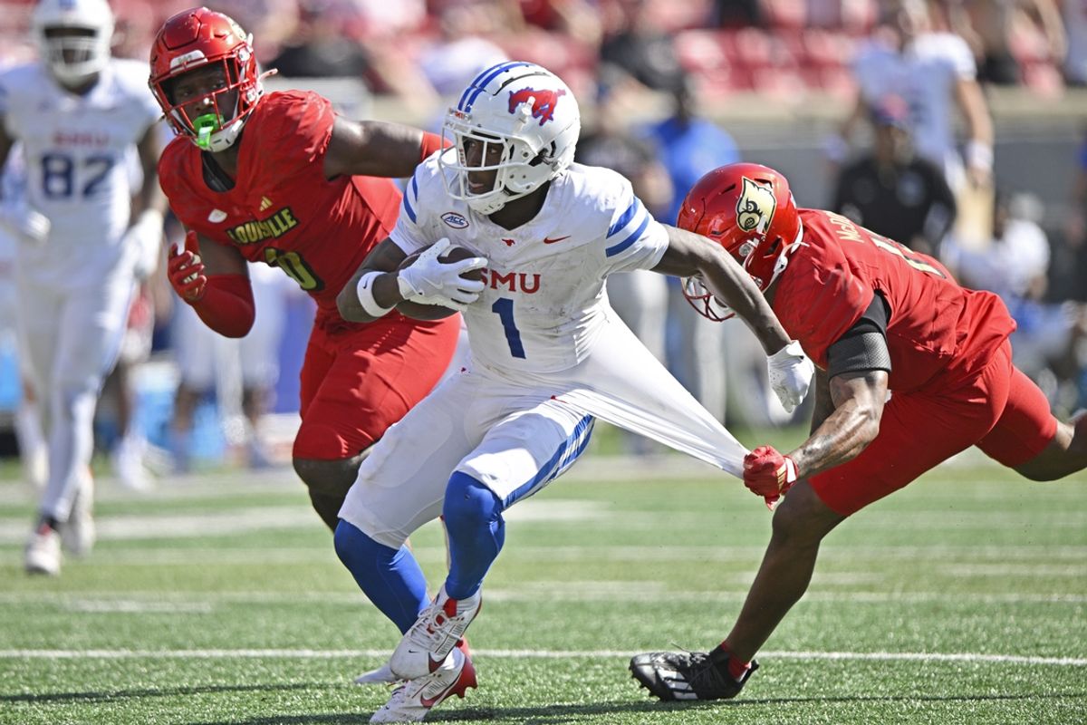 Oct 5, 2024; Louisville, Kentucky, USA;  Southern Methodist Mustangs running back Brashard Smith (1) runs the ball against Louisville Cardinals defensive back Tamarion McDonald (12) during the second half at L&N Federal Credit Union Stadium. Mandatory Credit: Jamie Rhodes-Imagn Images