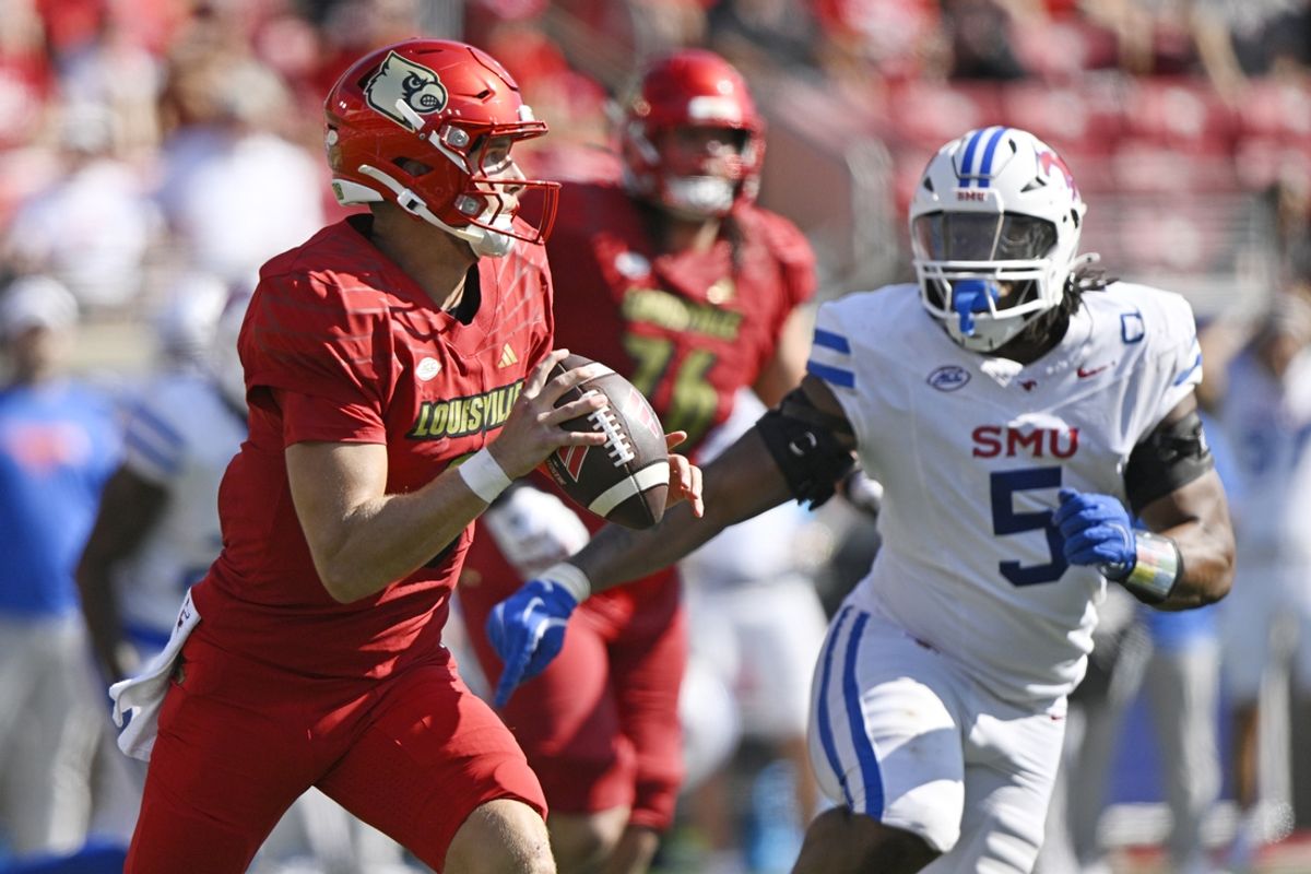 Oct 5, 2024; Louisville, Kentucky, USA;  Louisville Cardinals quarterback Tyler Shough (9) looks to pass against Southern Methodist Mustangs defensive end Elijah Roberts (5) during the second half at L&N Federal Credit Union Stadium. Mandatory Credit: Jamie Rhodes-Imagn Images