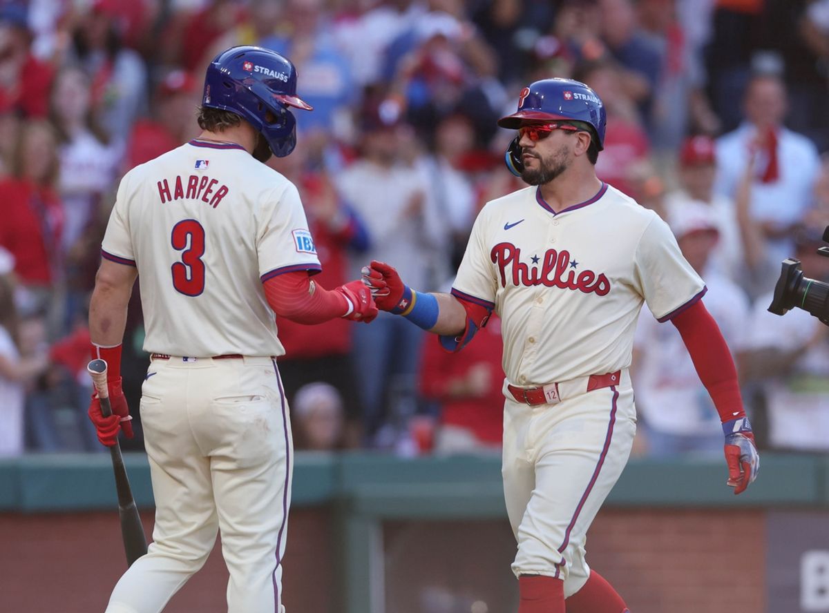 Oct 5, 2024; Philadelphia, PA, USA; Philadelphia Phillies designated hitter Kyle Schwarber (12) celebrates with Bryce Harper (3) after hitting a solo home run against the New York Mets in the first inning in game one of the NLDS for the 2024 MLB Playoffs at Citizens Bank Park. Mandatory Credit: Bill Streicher-Imagn Images
