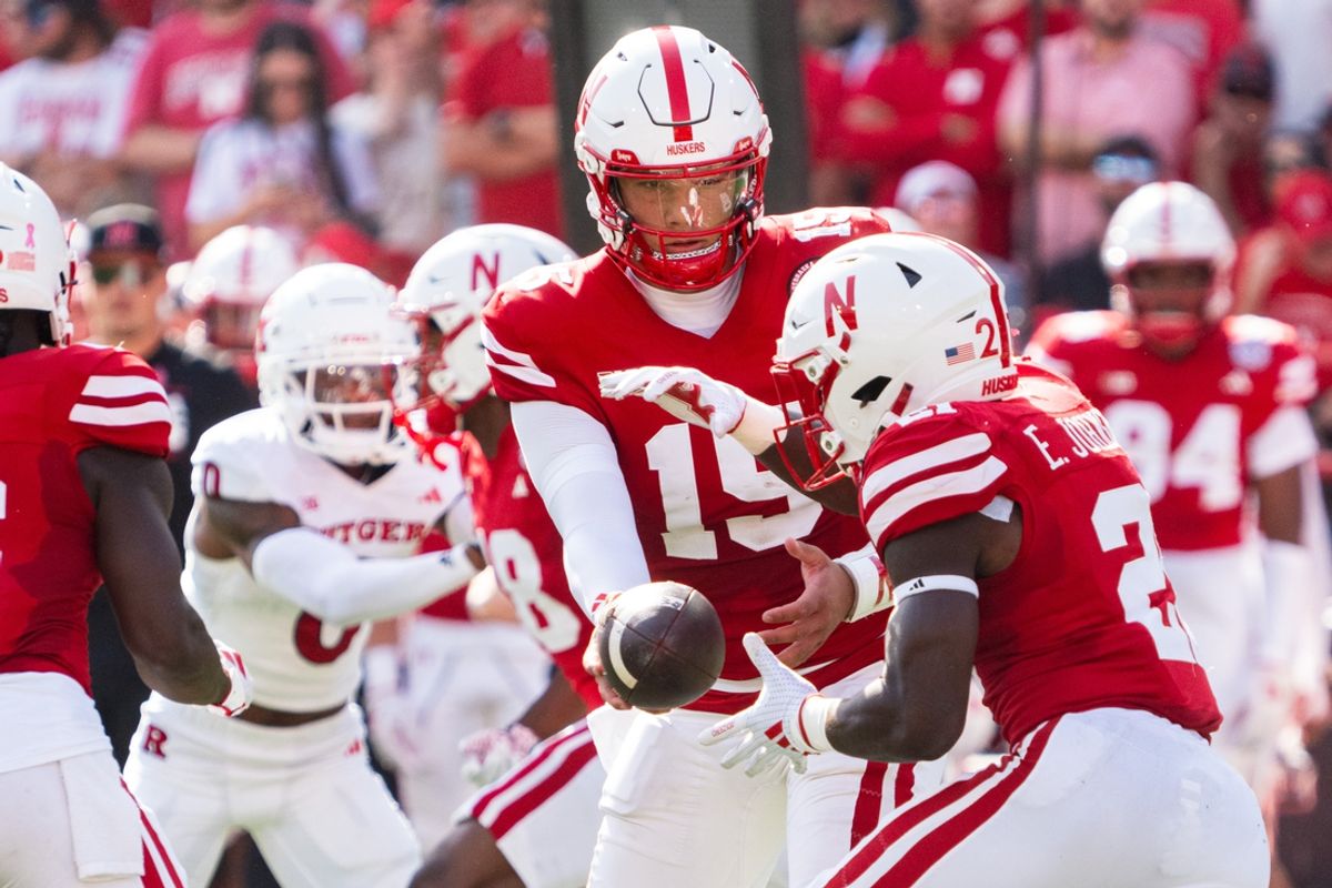 Oct 5, 2024; Lincoln, Nebraska, USA; Nebraska Cornhuskers quarterback Dylan Raiola (15) hands the ball off to running back Emmett Johnson (21) against the Rutgers Scarlet Knights during the first quarter at Memorial Stadium. Mandatory Credit: Dylan Widger-Imagn Images