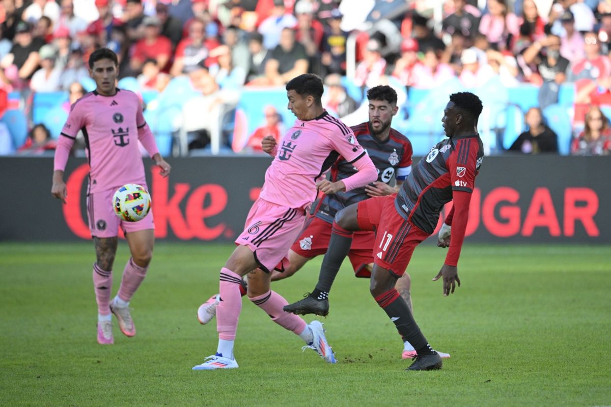 Oct 5, 2024; Toronto, Ontario, CAN; Inter Miami CF midfielder Tomas Aviles (6) tackles the ball away form Toronto FC midfielder Derrick Etienne (11) in the first half at BMO Field. Mandatory Credit: Dan Hamilton-Imagn Images