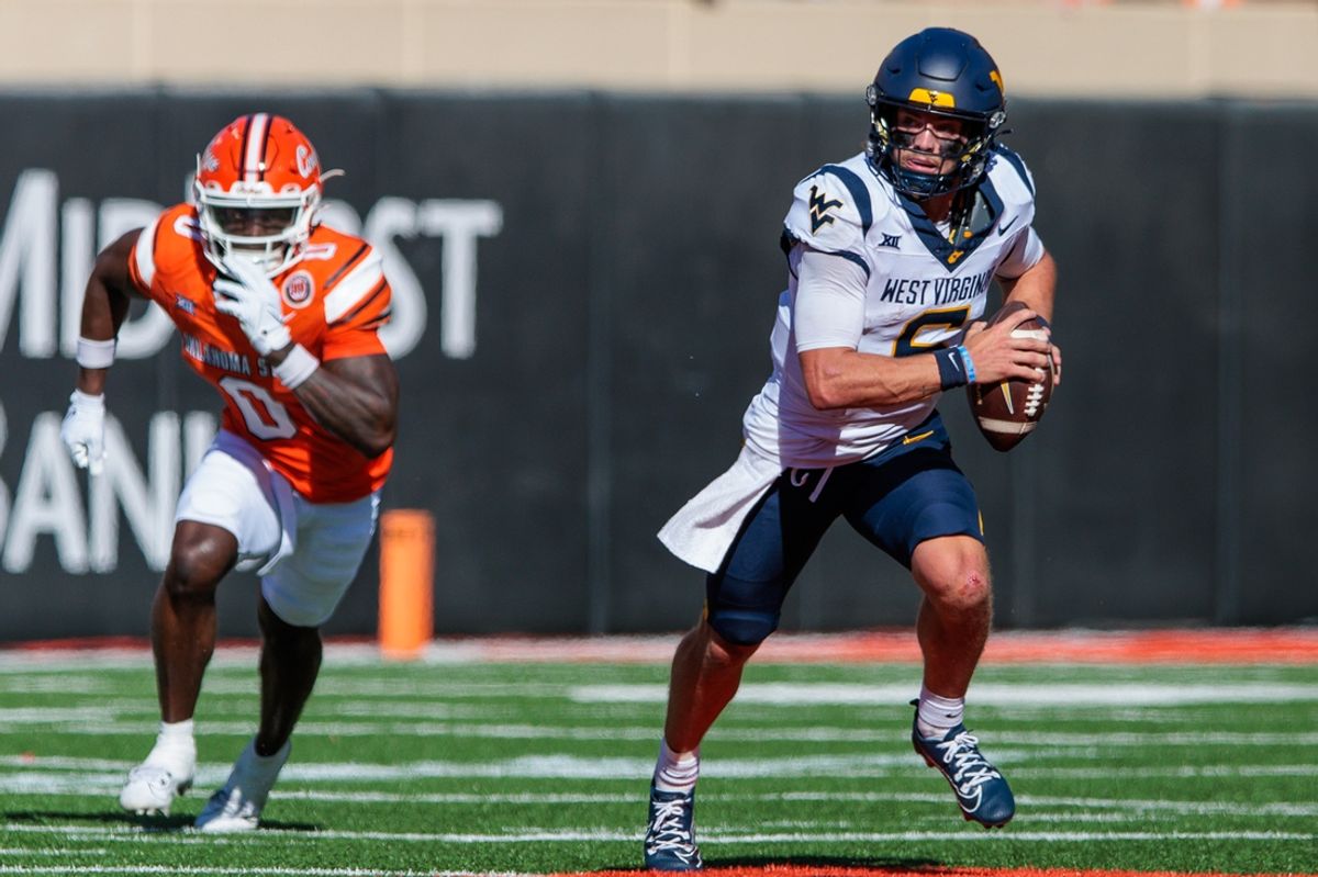 Oct 5, 2024; Stillwater, Oklahoma, USA; West Virginia Mountaineers quarterback Garrett Greene (6) scrambles in the backfield against the Oklahoma State Cowboys during the second quarter at Boone Pickens Stadium. Mandatory Credit: William Purnell-Imagn Images